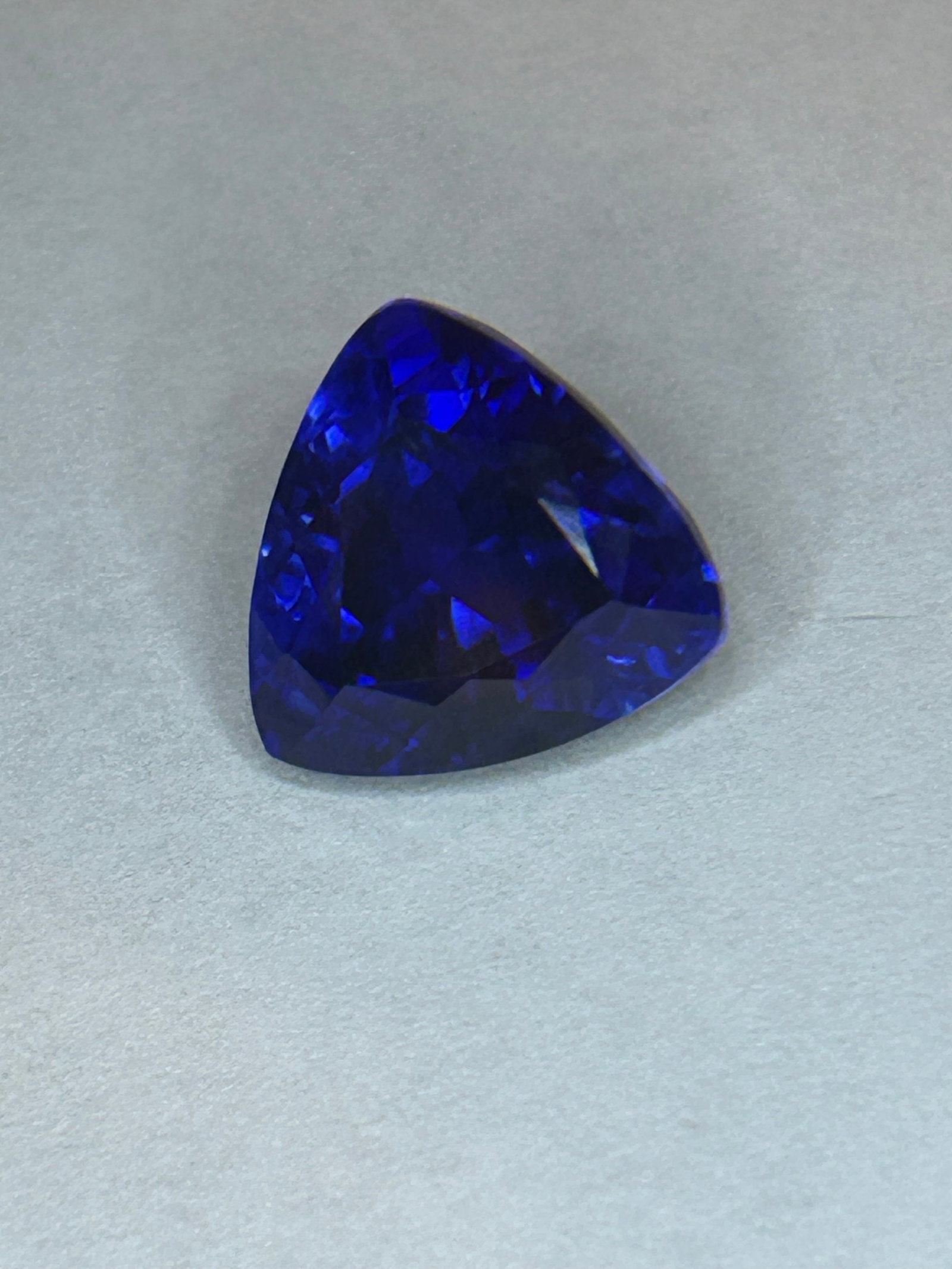 10.42 Carat -- Montana Deep Blue Sapphire --- Trillion Cut: The trillion cut offers a bold, modern geometric shape that maximizes light return to showcase the sapphire’s oceanic blue hue and vibrant internal fire. A rich navy hue. It provides outstanding sci