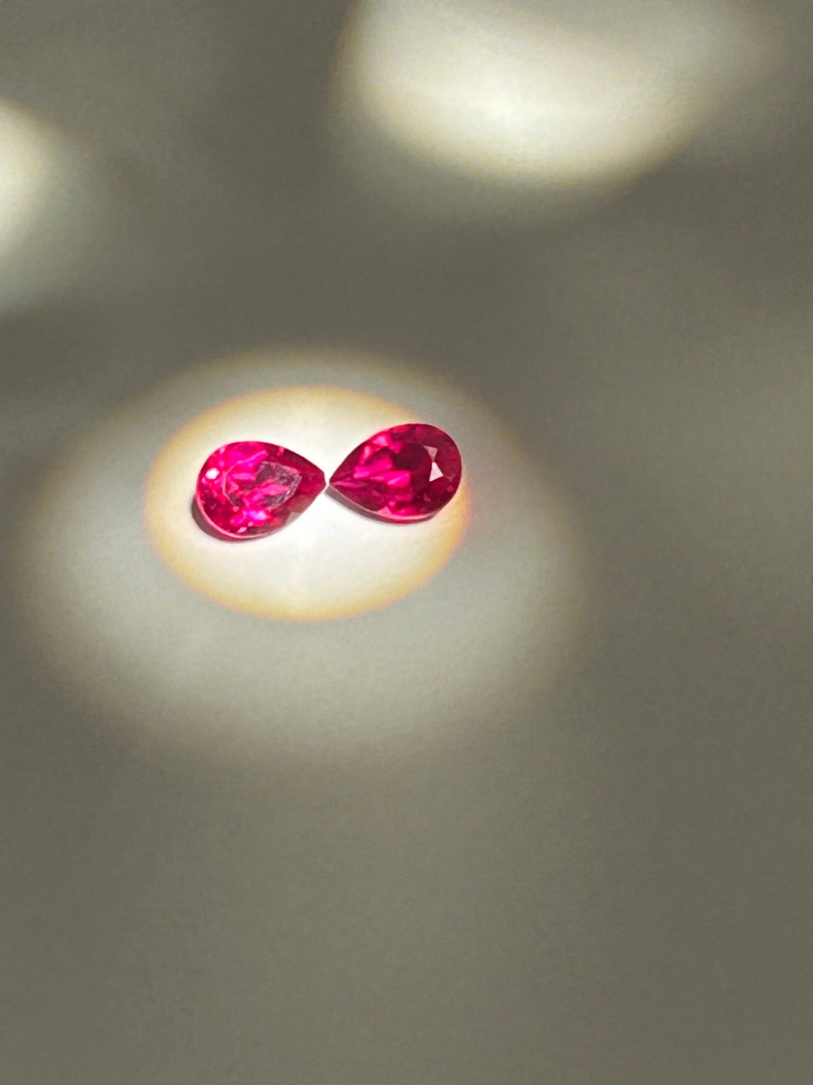 2 Carat ---- Burmese Blood Red Rubies ---- Pear Cut: A matched pair of 2-carat Burmese Blood Red pear-cut rubies represents an ultra-rare, top-tier gemstone investment. Highly coveted for a vivid, saturated hue and glowing red fluorescence, this