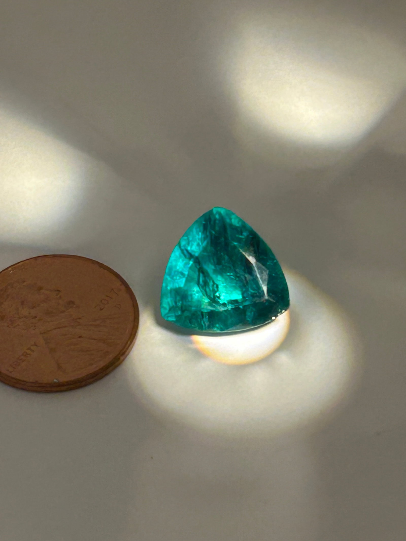 8 Carat ---- Green Emerald ---- Trillion Cut: A modern, and vibrant gemstone. The trillion cut's triangular shape offers brilliant light reflection, making it a stunning centerpiece for luxury, statement jewelry. From Large lot.