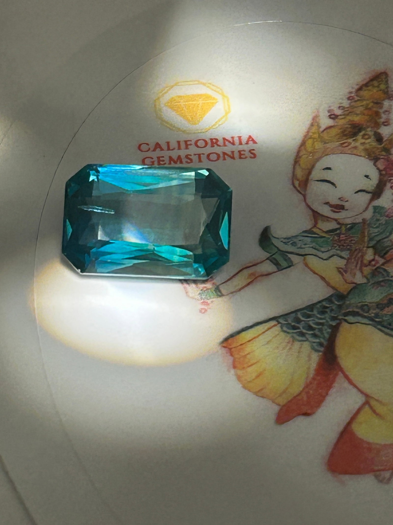 12.80 Carat ---- Natural Indian Green Sapphire ---- Emerald Cut ---- European Gem Lab Certified: A stunning Emerald cut, this gemstone blends vibrant green hues with superior brilliance, making it a spectacular, highly resilient centerpiece for bespoke fine jewelry.