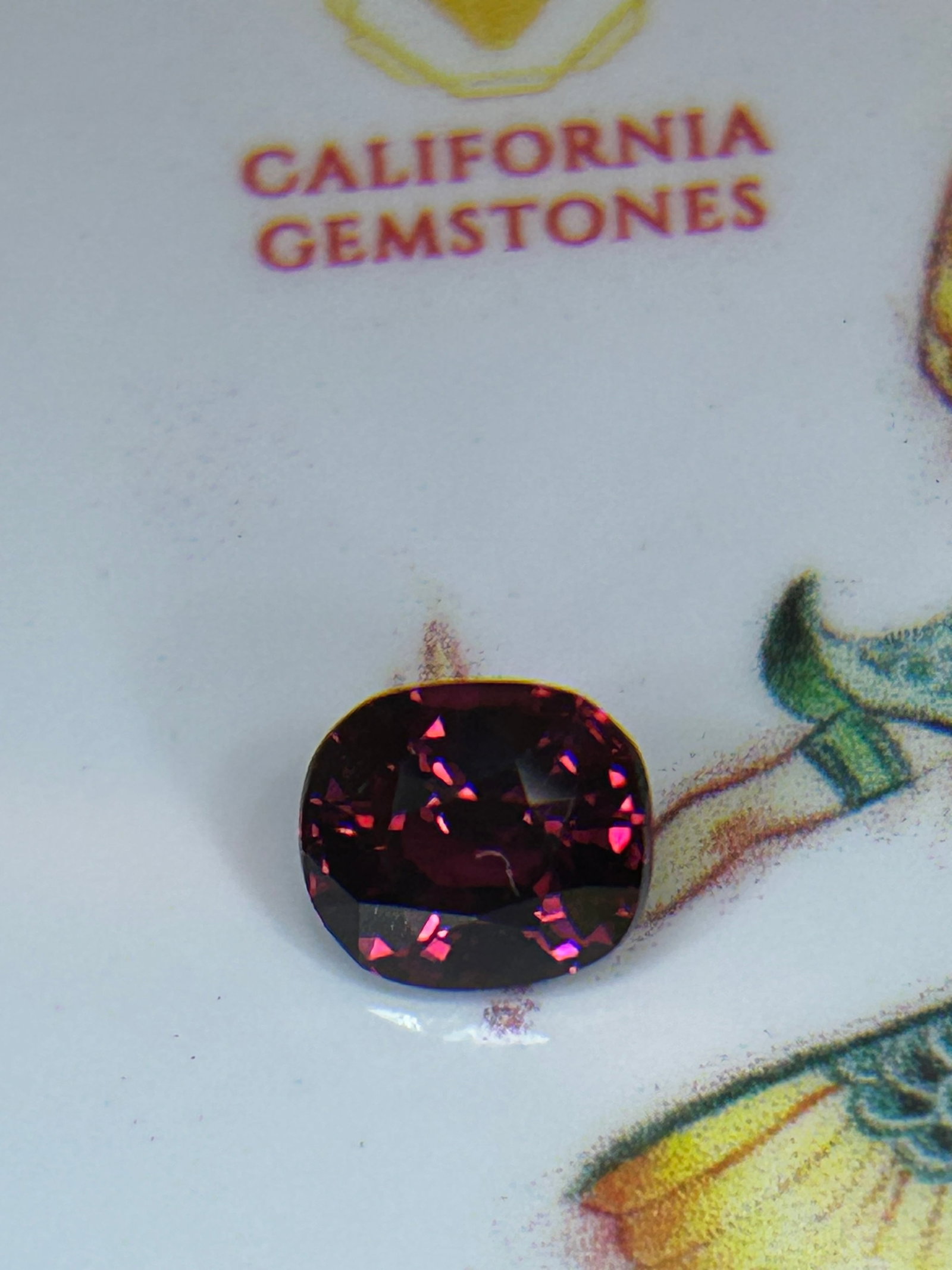 1.92 Carat ---- Natural Tanzanian Mahenge Garnet ---- Cushion Cut: The 1.92 Carat Tanzanian Mahenge Garnet is a rare, vivid, untreated color-shifting gem. It displays saturated pink, raspberry, or magenta hues and is renowned for a unique flash of dispersion. It is