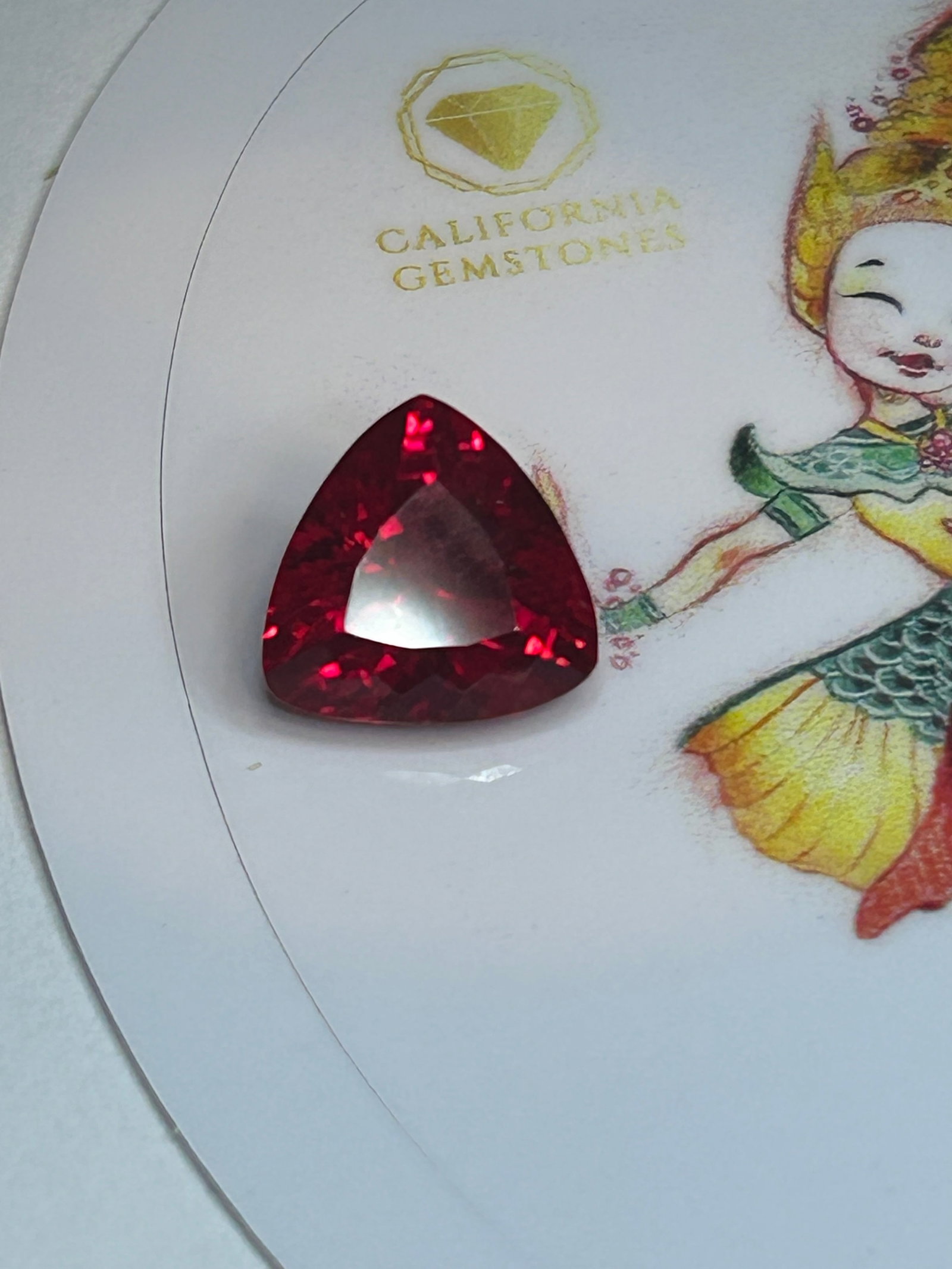 9 Carat ---- Natural Burmese Blood Ruby ---- Trillion Cut ---- Certified: A highly coveted gemstone, originating from Burma. It features a deep, intense red hue—often termed "pigeon blood"—with slight blue undertones, a luxurious, velvety saturation, and a cushioned sha