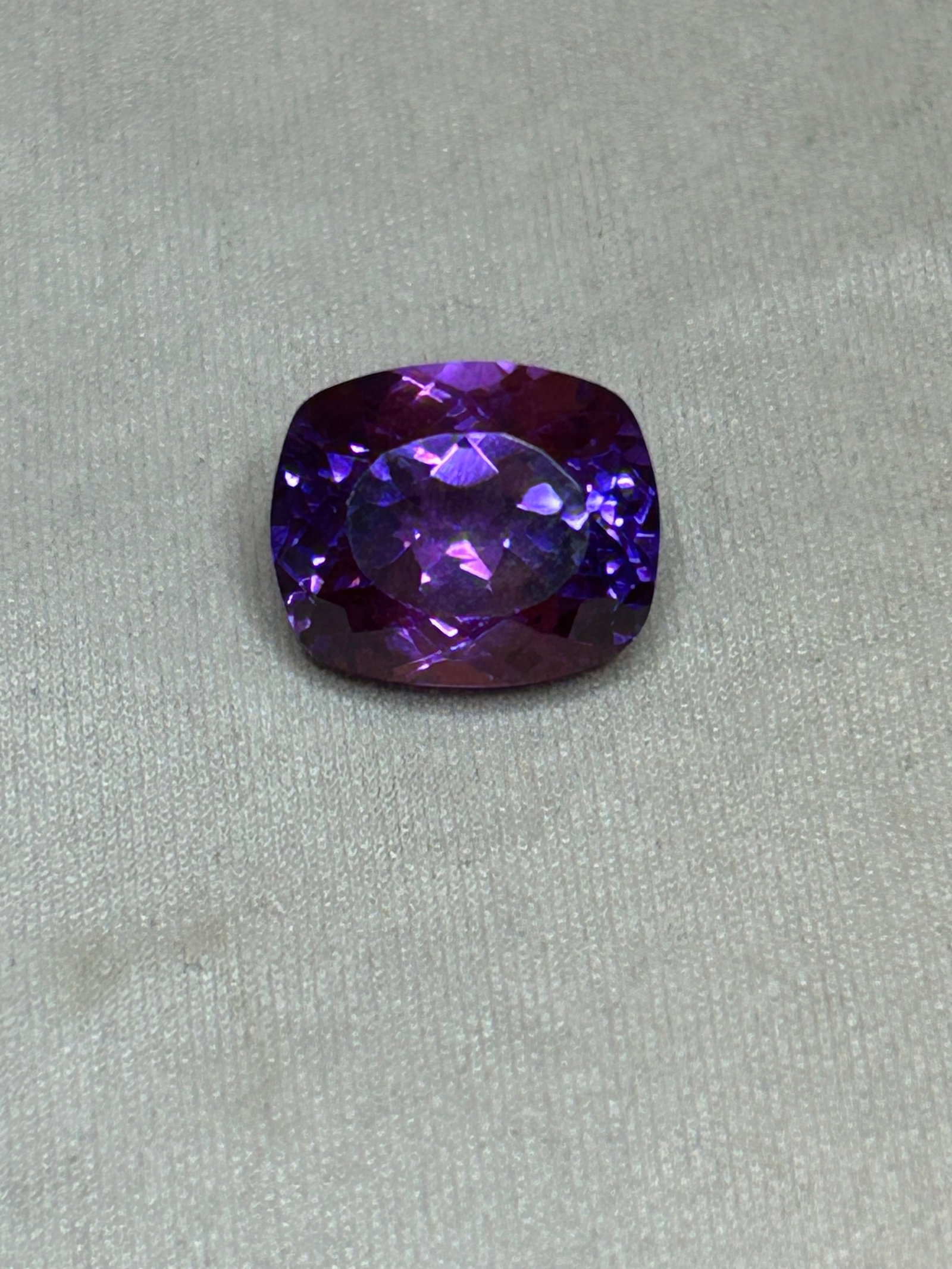 10.45 Carat ---- Natural Purple Tanzanite----Brilliant Oval Cut ----AGL Certified: Originating from Tanzania. It features vibrant purple hues, strong pleochroism (showing shifting violet and reddish-purple tones depending on the light or viewing angle), and eye-clean transparency.