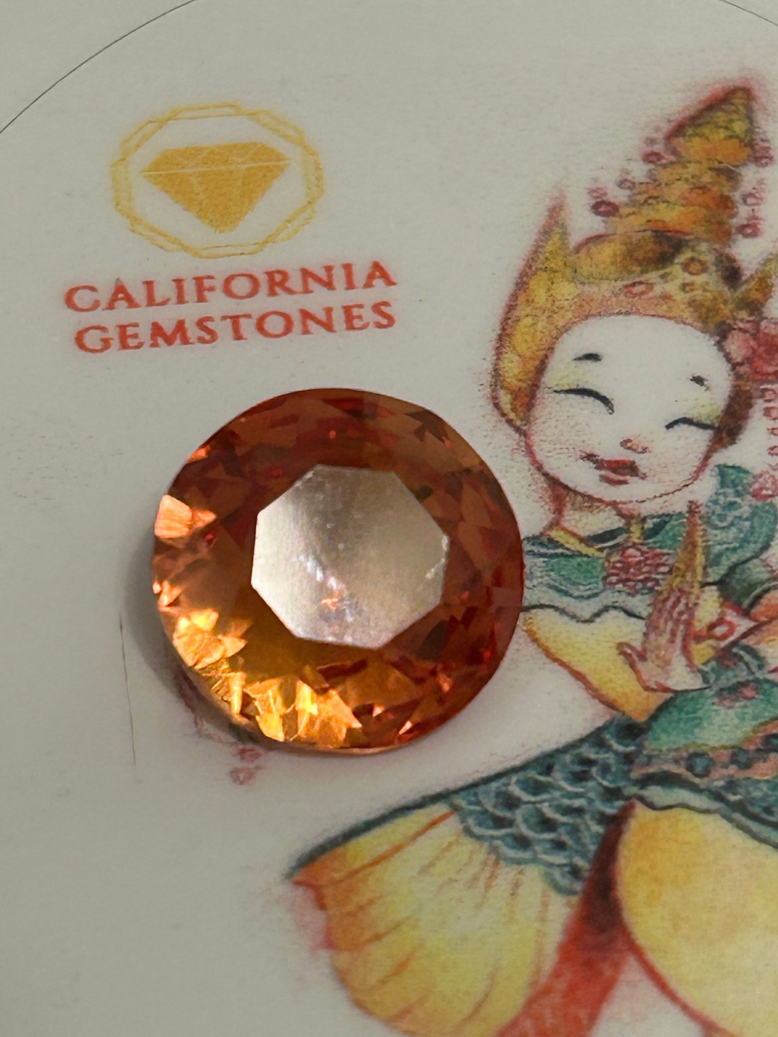 5.00 Carat --Orange Sapphire----Round Cut----GGI Certified: This brilliant-cut gem offers a fiery, vivid glow and is highly prized for custom engagement rings and fine jewelry. Round Brilliant Cut. Faceted to maximize light return and fire.