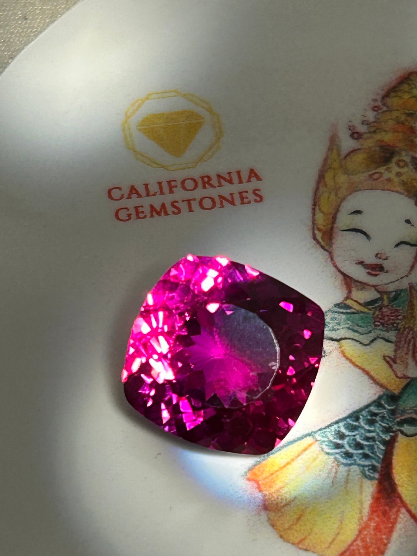 14.00 Carat -- Natural Mogok Rose Red Ruby-- Brilliant Cushion Cut: An exceptionally spectacular gemstone. This extraordinary 14.00-carat natural ruby is a true masterpiece of nature. Sourced from the legendary mines of Mogok, Myanmar, it carries the prestigious pedig