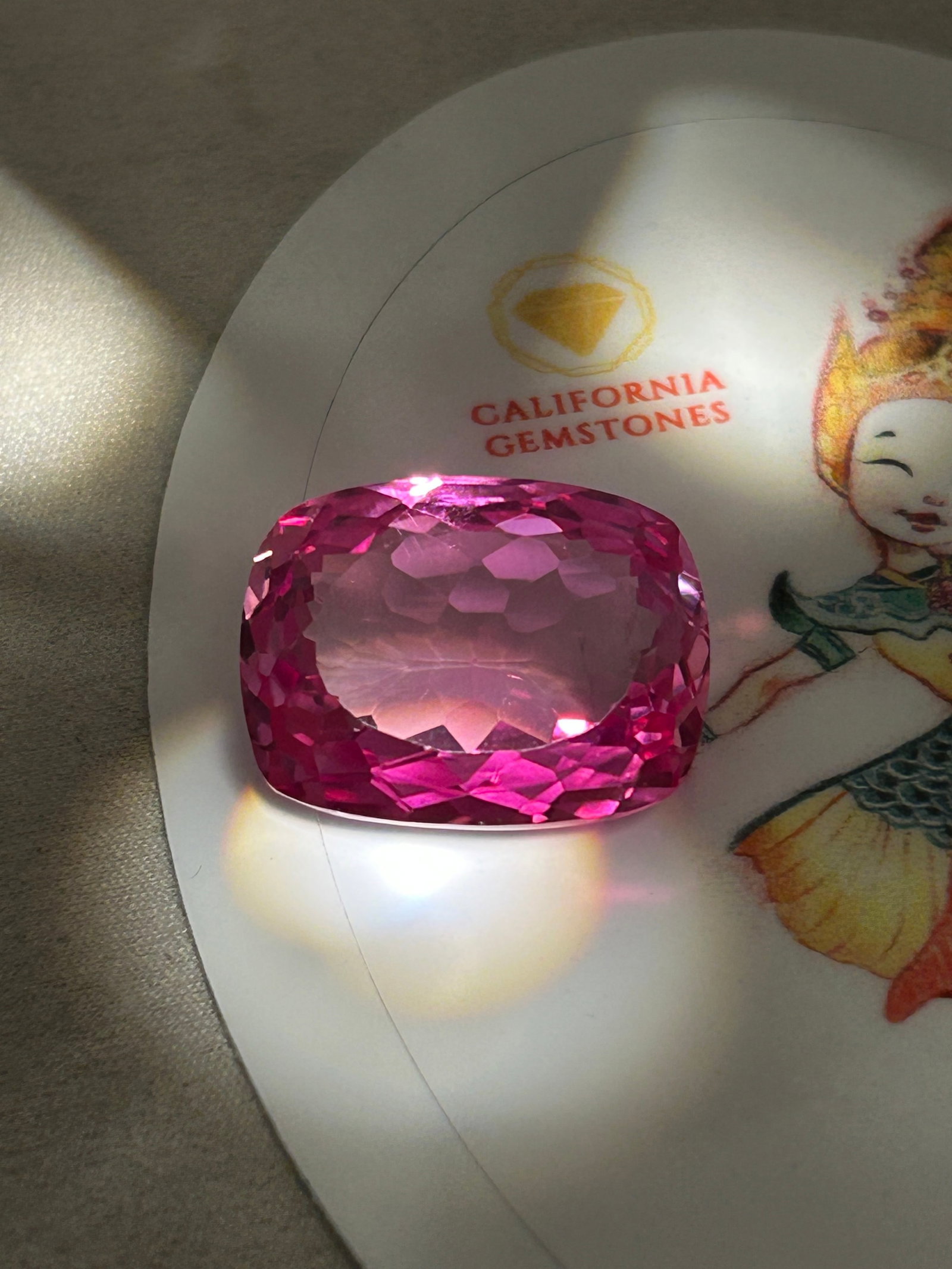 25.0 Carat --- Natural Padparadscha Sapphire ---- Modified Cushion Cut: An exceptional massive gem. A modified cushion cut combines a square or rectangular outline with rounded corners and features extra faceting to maximize brilliance, reduce windowing, and intensify its