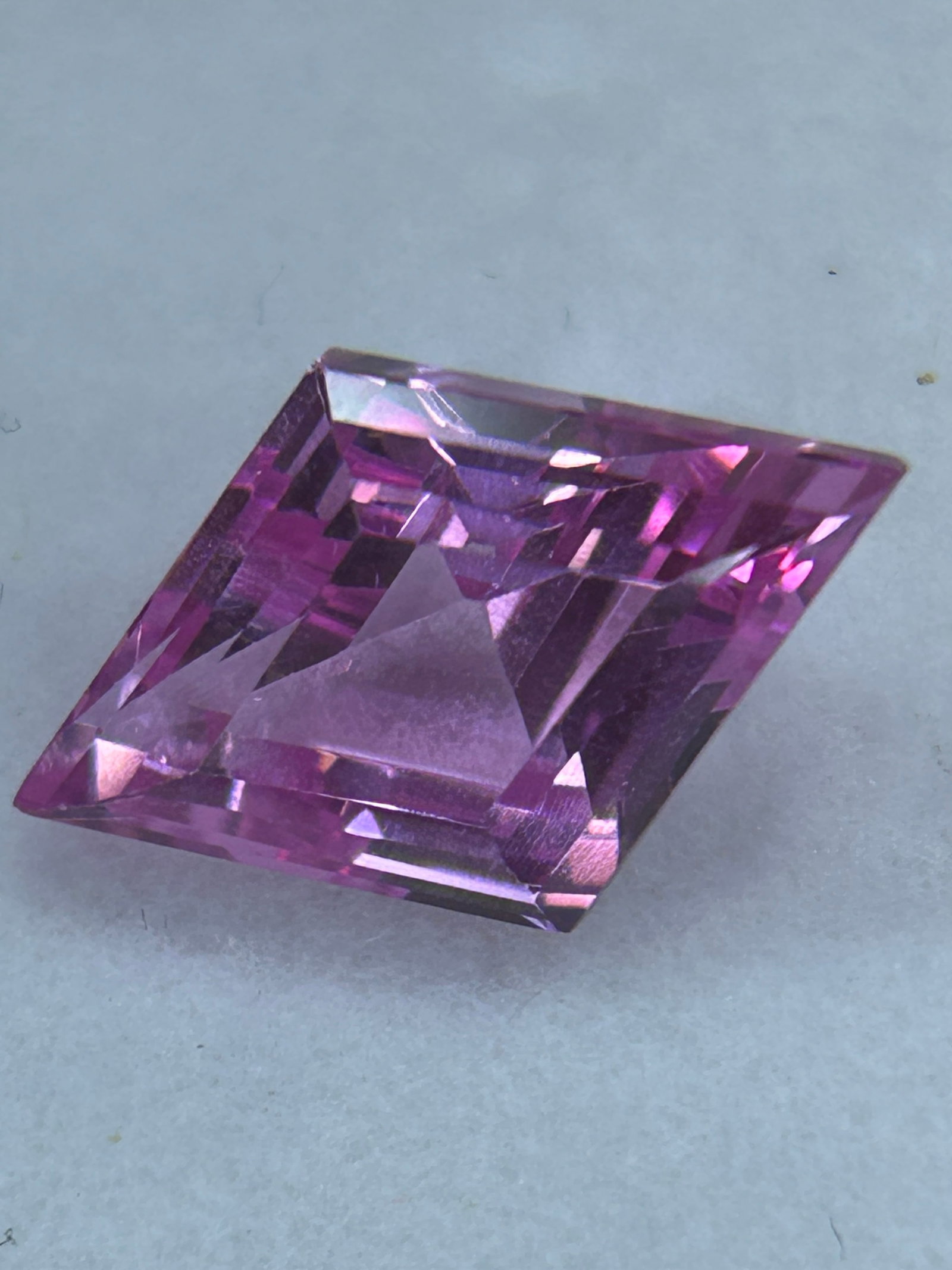 12.25 Carat Natural Padparadscha Sapphire Brilliant Fancy Lozenge Cut EGL Certified: Genuine Padparadscha requires a delicate, balanced mix of pink and orange resembling a tropical sunset. Brilliant Fancy Lozenge (a geometric, symmetrical four-sided rhombus shape with brilliant-style 