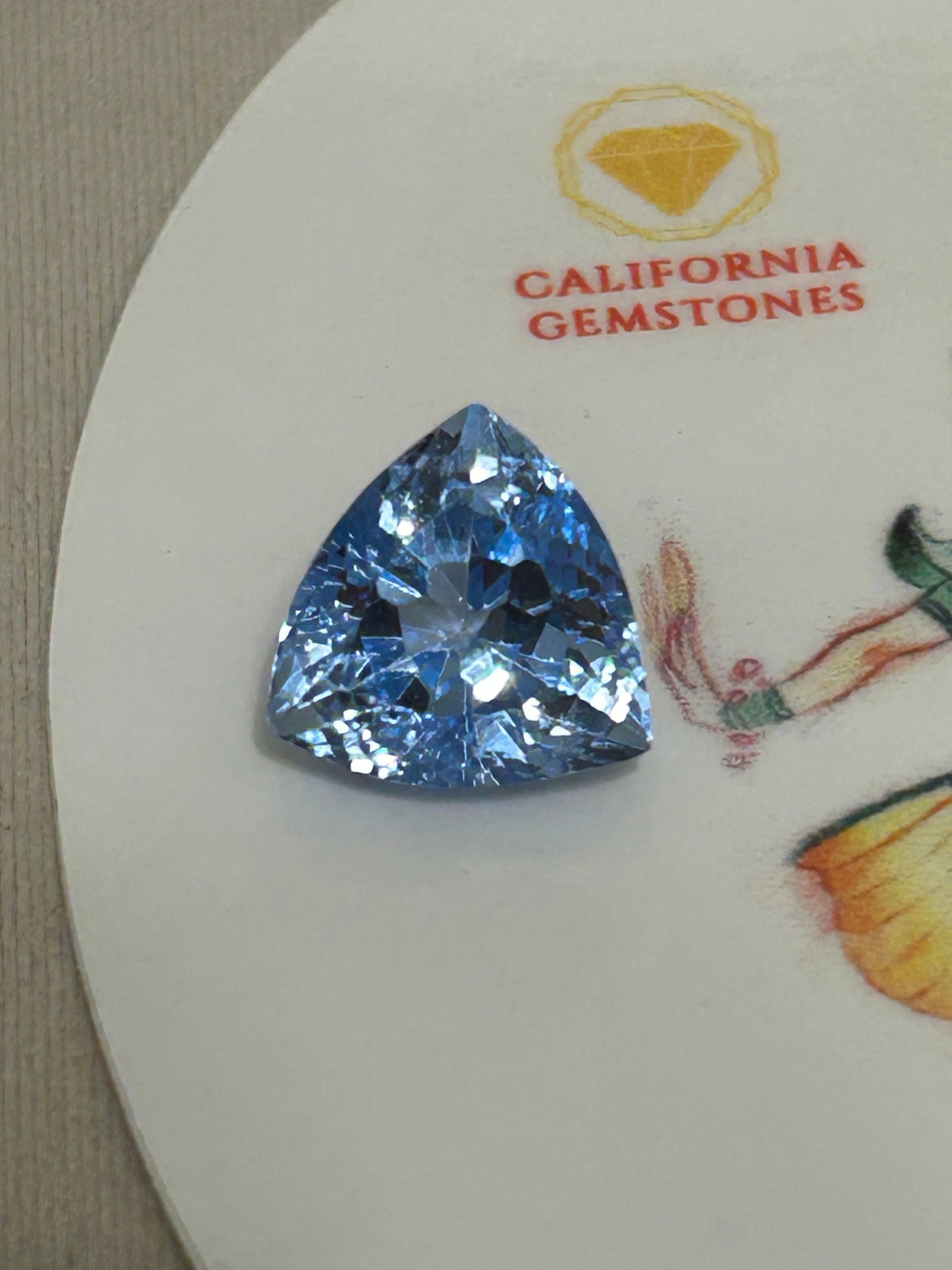 11 Carat ---- Natural Brazilian Aquamarine ---- Brilliant Trillion Cut: A natural Brazilian aquamarine in a brilliant trillion cut is a large, triangular gemstone featuring a crisp modern shape, high transparency, and an ocean-to-sky blue hue sourced from the renowned min