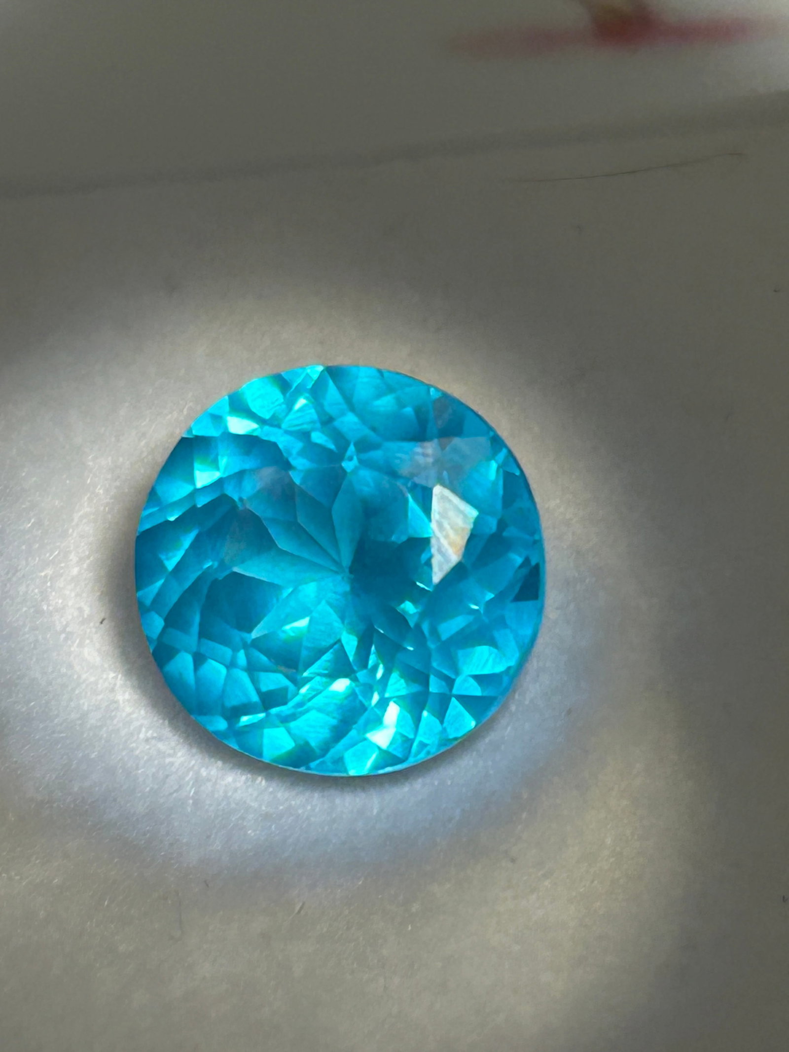 4 Carat ---- Brazilian Tourmaline ---- Brilliant Round Cut: Brazilian tourmaline is an exceptionally rare, large copper-bearing gemstone featuring electric neon-blue to greenish-blue hues, symmetrical round facet geometry, and high market value due to its