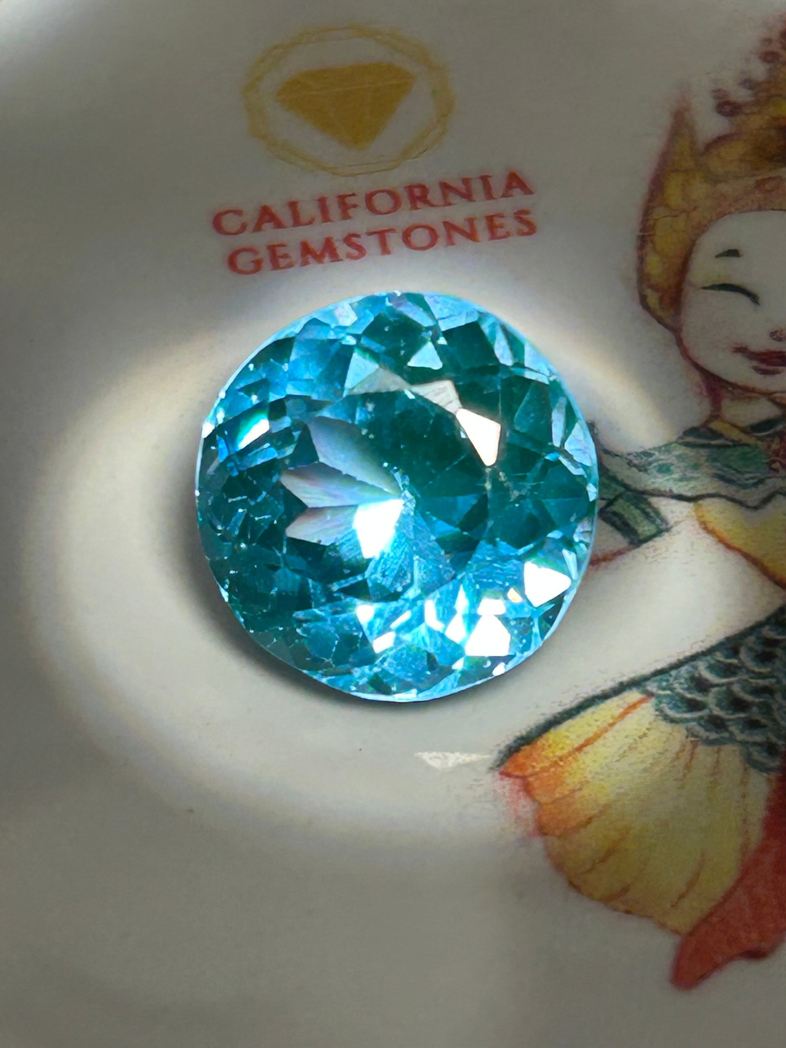 11.95 Carat --- Natural Brazilian Blue-Green Tourmaline --- Round Cut: Copper-Bearing Brazilian Paraíba Tourmaline. An exceptional and highly valuable gemstone. Stones of this size and color belong to the prestigious Paraíba variety, celebrated worldwide for its vibran