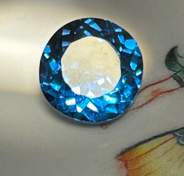 5.45 Carat ---- Natural Blue Tourmaline ----Brilliant Round Cut: A collector-level gemstone. A brilliant round cut maximizes its fire, while the deep oceanic to teal-blue colors exhibit strong pleochroism (displaying shifting light and dark blues). High-clarity, un