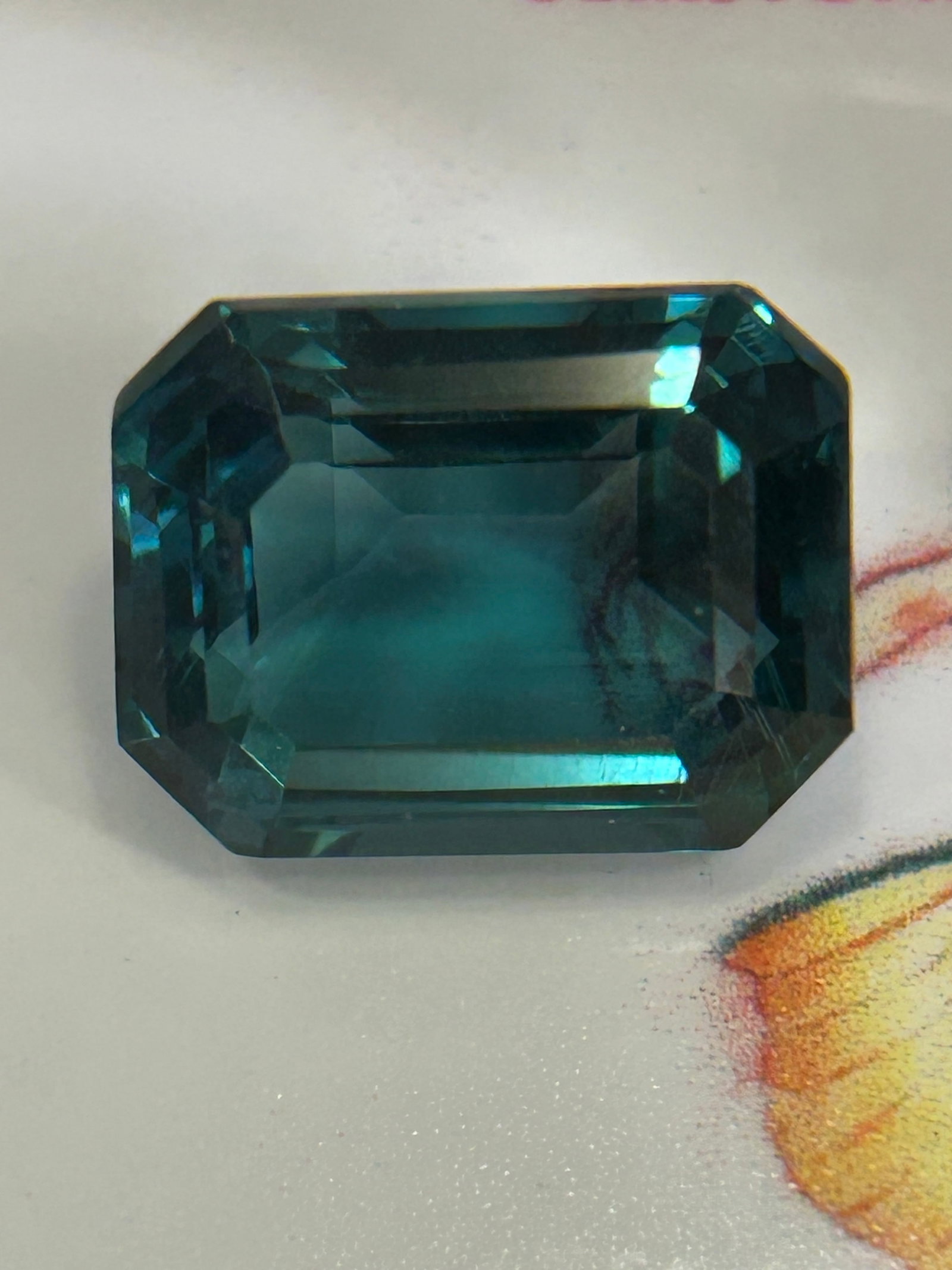 10.00 Carat Natural Teal Sapphire Emerald Step Cut: Emerald step cuts have open, flat tables that expose internal inclusions, making high eye-clean clarity crucial for top-tier valuation. Unheated natural teal sapphires command a substantial premium.