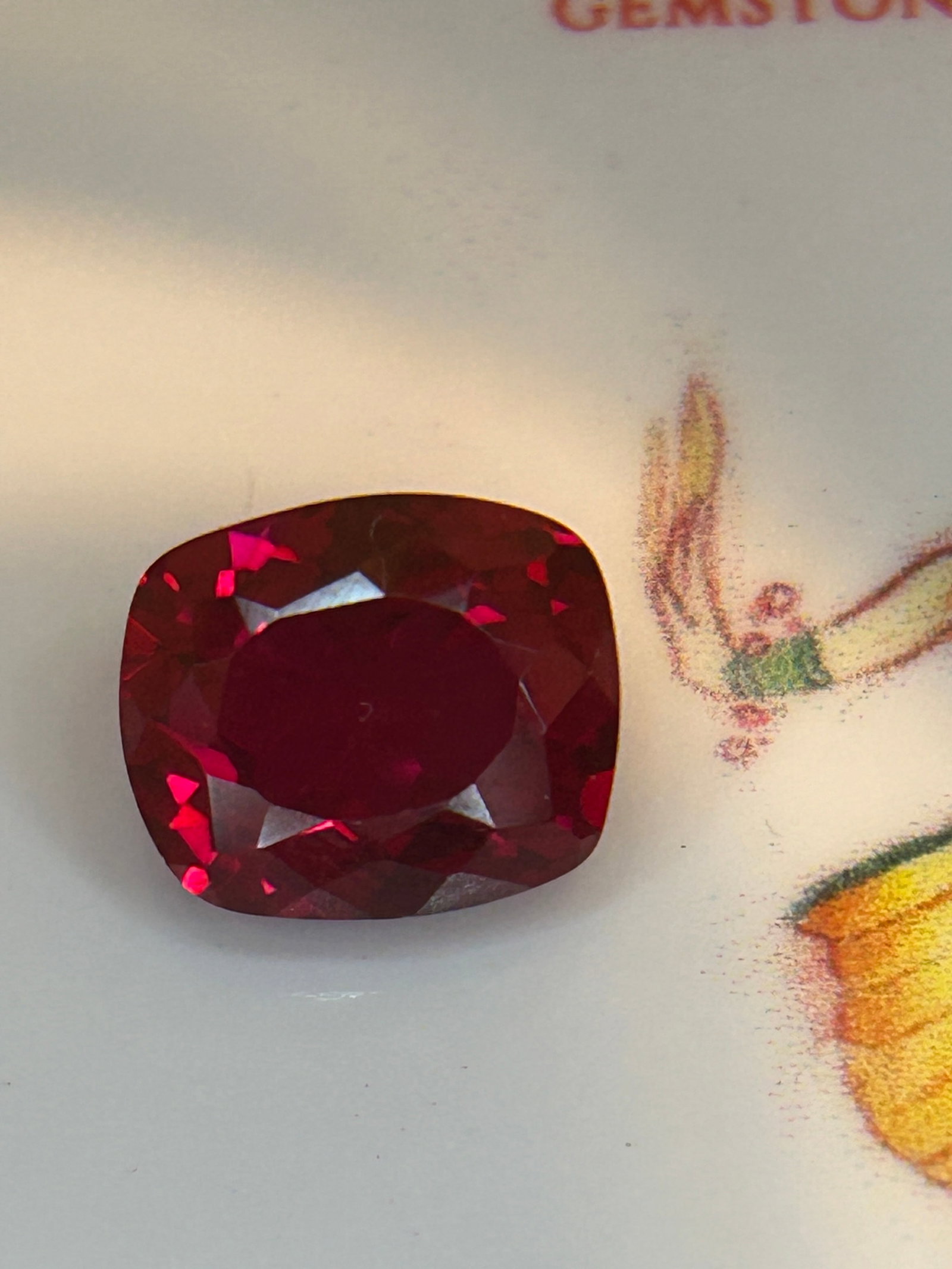 5.65 Carat Natural Mozambique Blood Ruby Mixed Cushion Cut: A vivid crimson color, a soft rectangular shape with rounded corners, and brilliant-style facets on the crown with step-style facets on the pavilion.
