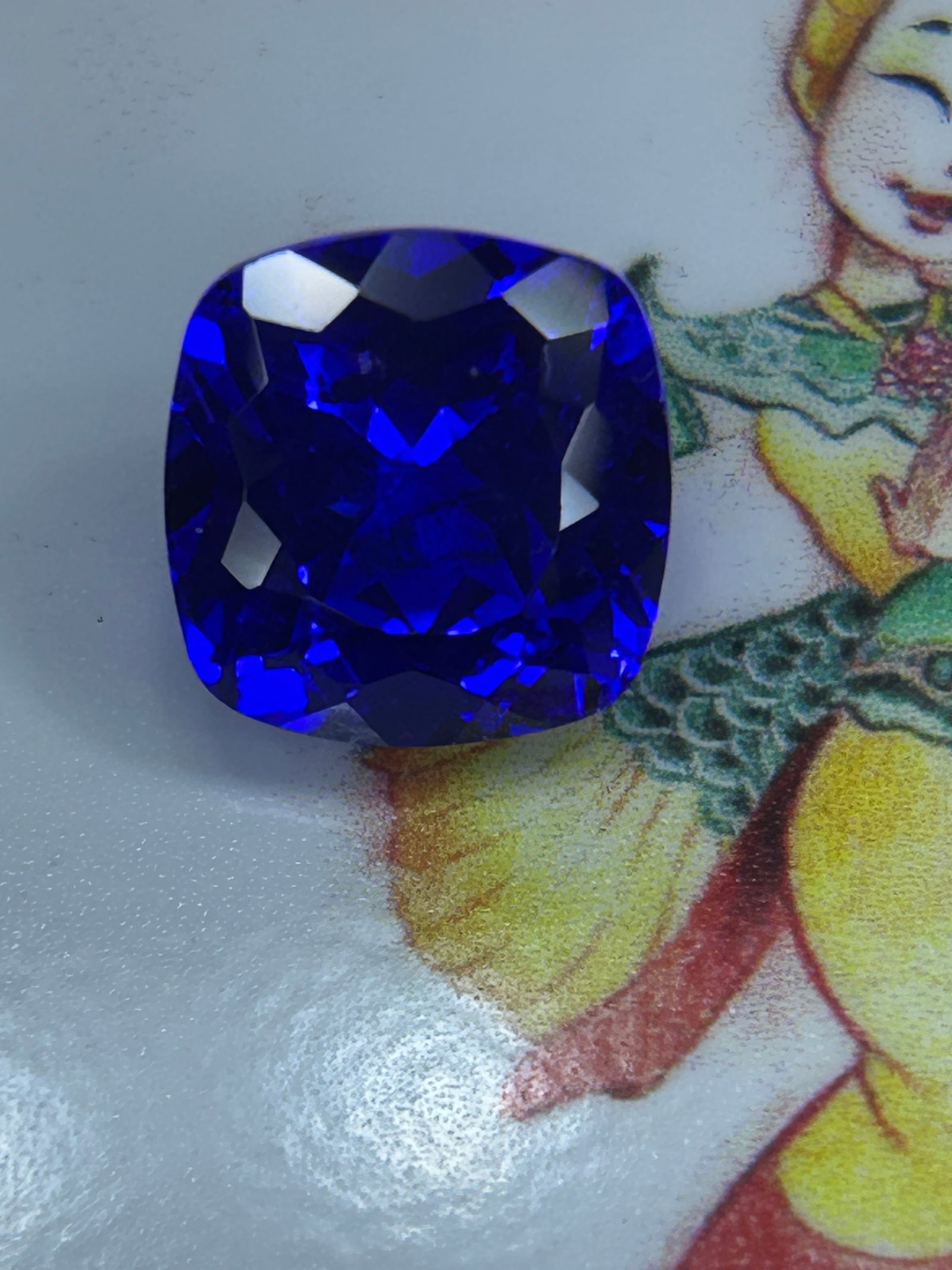 12.05 Carat Natural Ceylon Royal Blue Sapphire Cushion Cut: featuring a rich blue hue, a soft cushion shape, and origin from Sri Lanka. A deep, rich, vivid, and velvety blue saturation that remains bright in daylight without looking too dark or too pale.