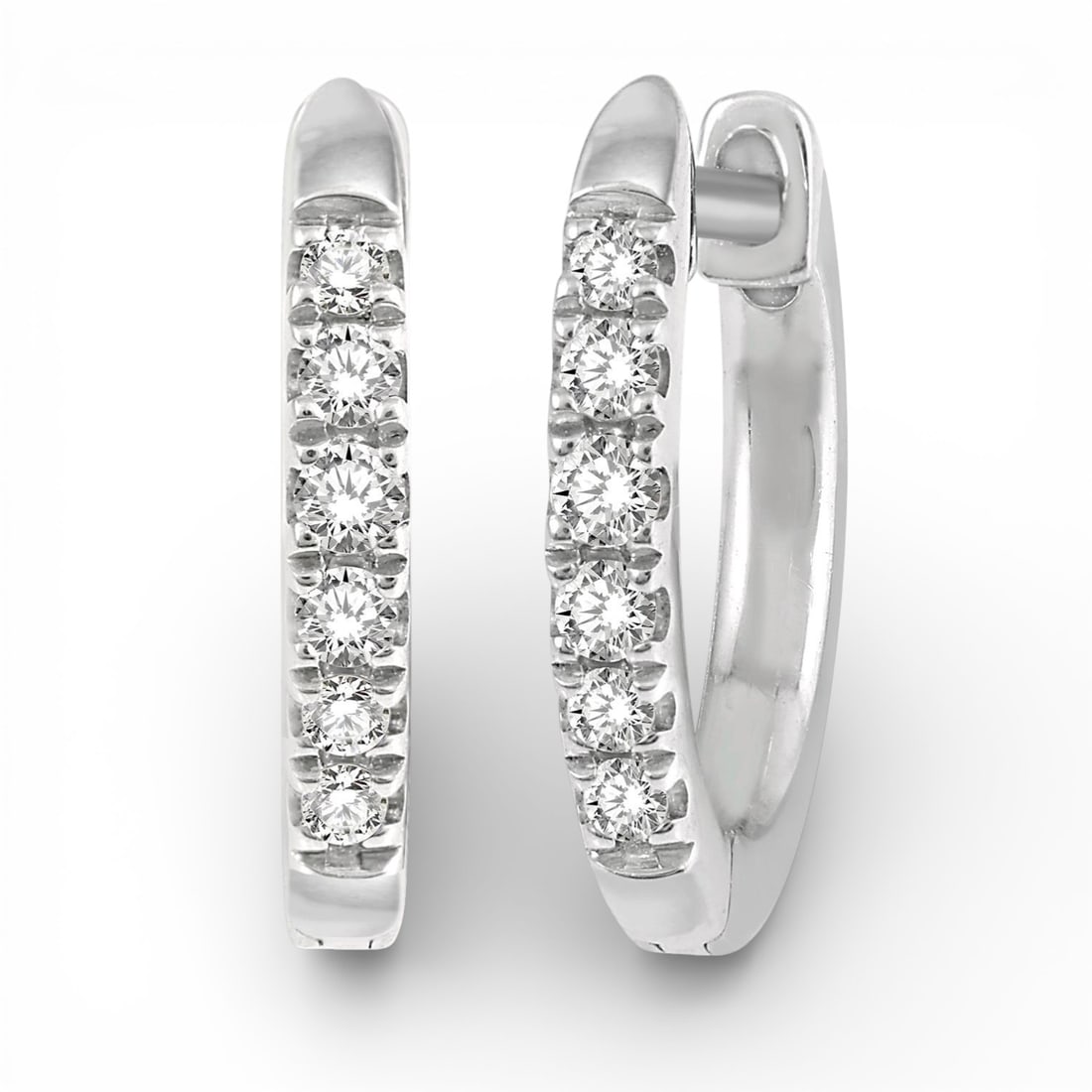 0.12 ctw Diamond Huggie Petite 10K White Gold Earrings: A testament to superior craftsmanship, this elegant Petite Huggie pair of earrings featuring White Diamond is unparalleled. Showcasing the gems in a Channel-Set arrangement, the earrings consists of 1
