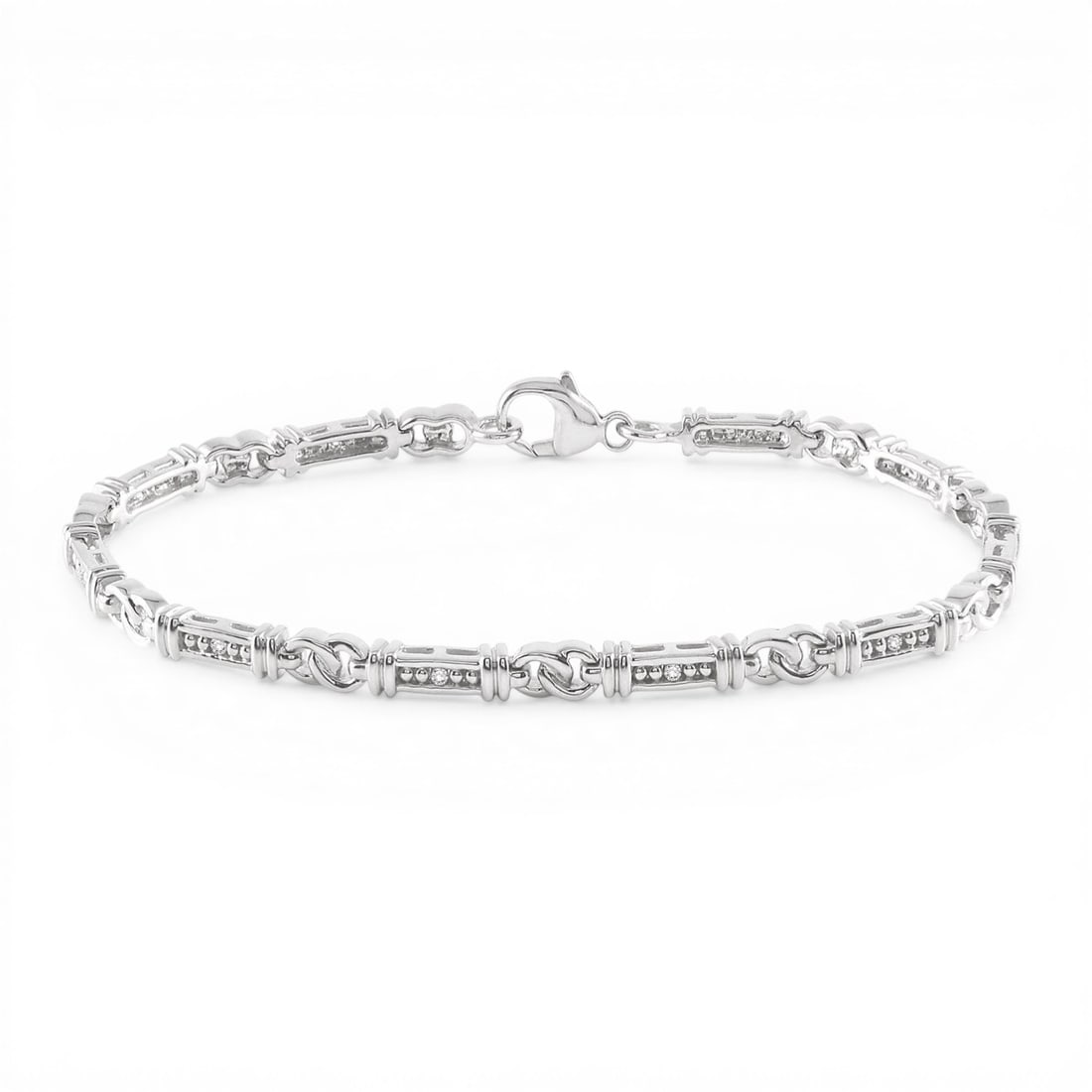 7.0 inch 0.10ctw Diamond Knot Link Sterling Silver Bracelet: A testament to superior craftsmanship, this elegant Knot Shape bracelet featuring White Diamond is unparalleled. A detailed Link gallery secures the stones, rendered in 10.45 grams of lustrous Sterlin