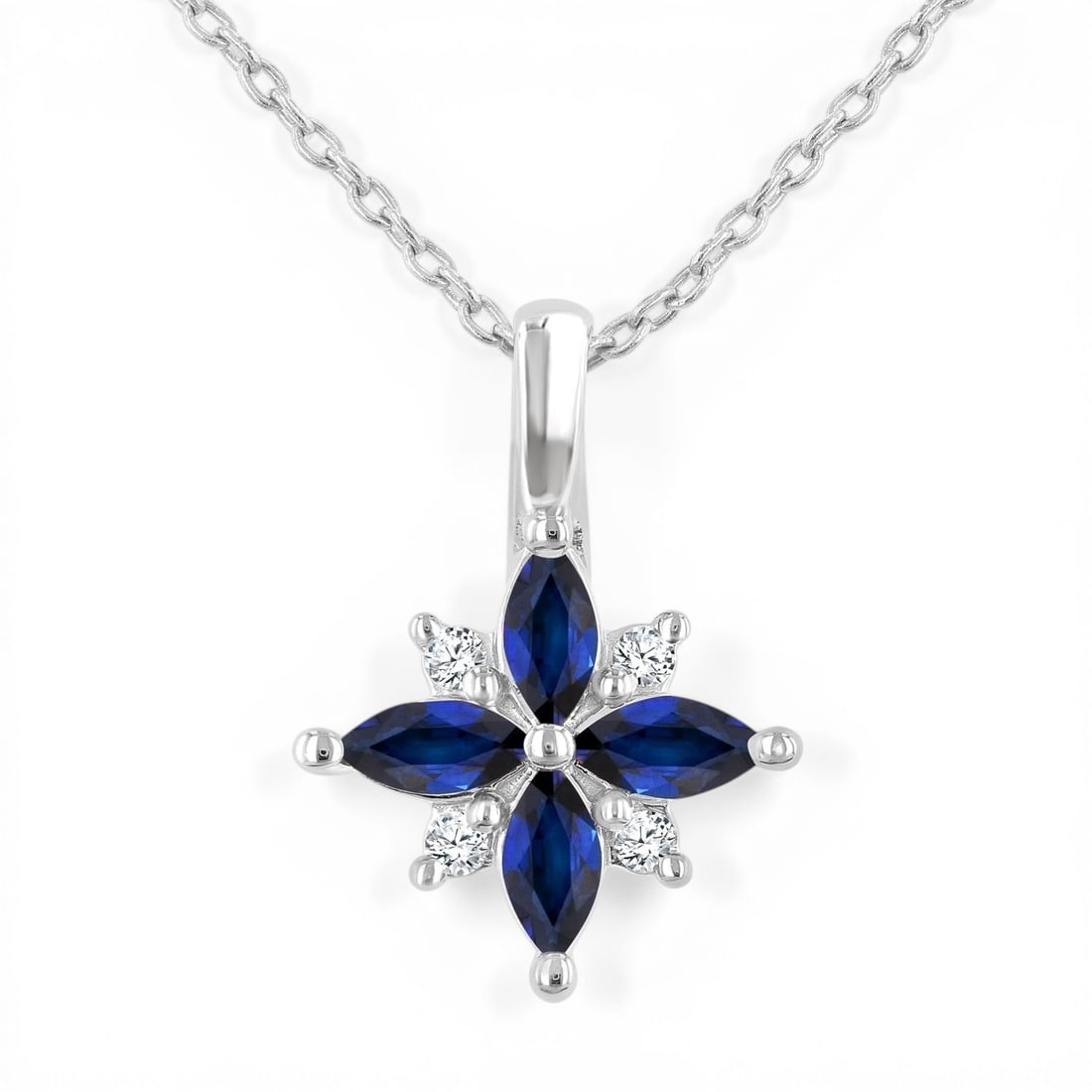 4x2mm Sapphire and 0.04ctw Diamond 10K White Gold Pendant: A vision of luxury, this elegant Blossom pendant featuring Sapphire, White Diamond defines sophistication. Securely held in a classic Cluster design, the pendant is forged from 1.2 grams of high-polis