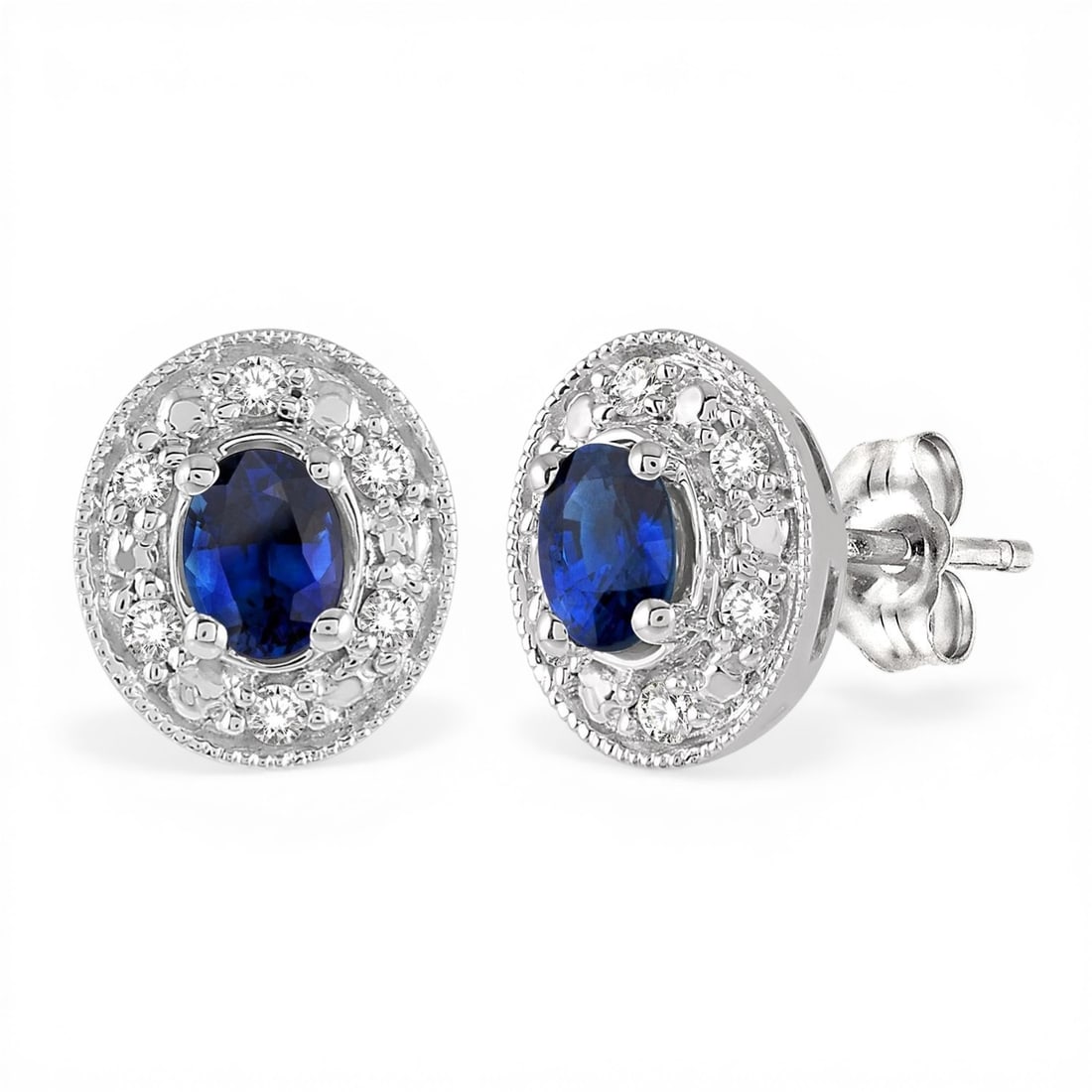 4x3mm Oval Sapphire and 0.10ctw Diamond 14K White Gold Earrings: An exquisite masterpiece of haute joaillerie, this elegant Oval Shaped pair of earrings featuring Blue Sapphire, White Diamond is a true treasure. Crafted with precision, the Halo setting is seamlessl