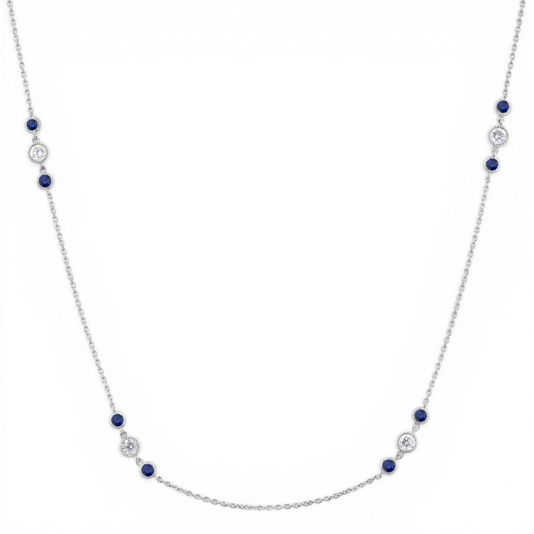 0.48ctw Diamond and 2.25mm Sapphire Station 14K White Gold Necklace: A vision of luxury, this exquisite Station necklace featuring Colorless Diamond, Blue Sapphire defines sophistication. The gemstones are nestled within a Station framework, supported by a substantial