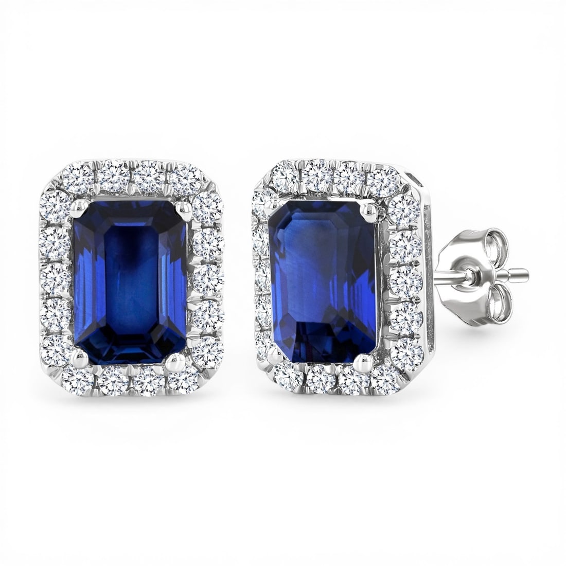6x4mm Blue Sapphire and 0.25ctw Diamond 14K White Gold Stud Earrings: An exquisite masterpiece of haute joaillerie, this breathtaking Halo pair of earrings featuring Blue Sapphire, White Diamond is a true treasure. A detailed Halo gallery secures the stones, rendered in