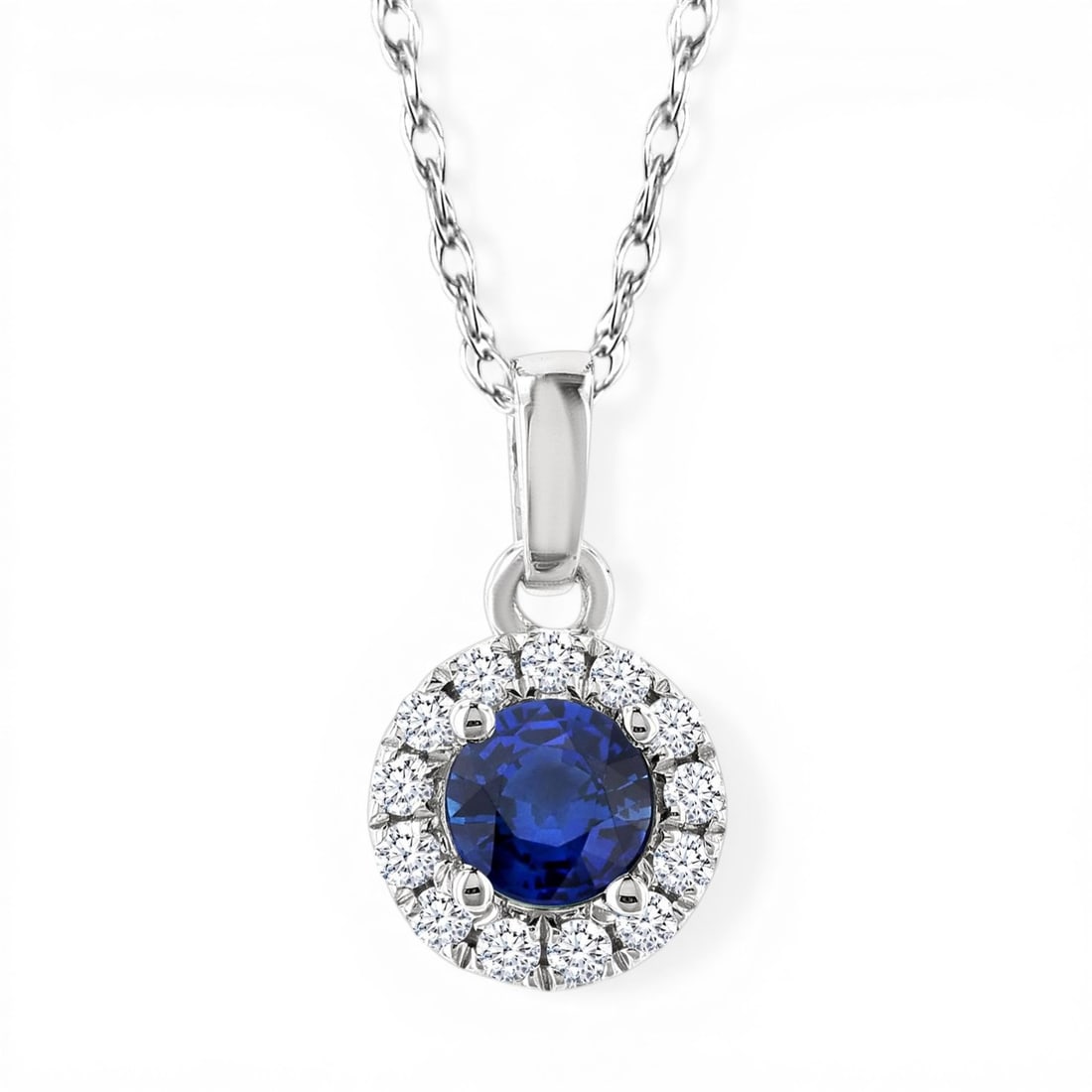 3.25mm Blue Sapphire and 0.05ctw Diamond Halo 10K White Gold Pendant: Epitomizing grandeur, this elegant Halo pendant featuring Blue Sapphire, White Diamond stands as a beacon of refined taste. Crafted with precision, the Halo setting is seamlessly integrated into 0.3 g