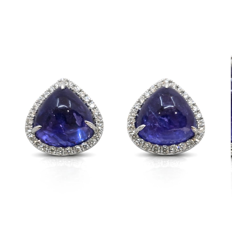14.89ct Tanzanite and 0.64ctw Diamond 14K White Gold Stud Earrings: Epitomizing grandeur, this magnificent Halo pair of earrings featuring Tanzanite, White Diamond stands as a beacon of refined taste. A detailed Halo gallery secures the stones, rendered in 4.5 grams o