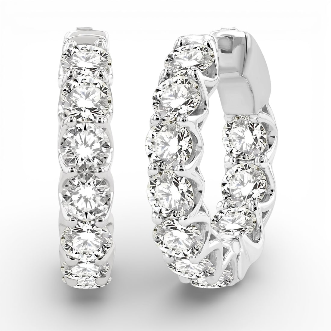 5.0 ctw Inside-Out White Diamond 14K White Gold Hoop Earrings: A vision of luxury, this stunning Inside-Out pair of earrings featuring White Diamonds defines sophistication. Securely held in a classic Hoop design, the earrings are forged from 9.85 grams of high-p
