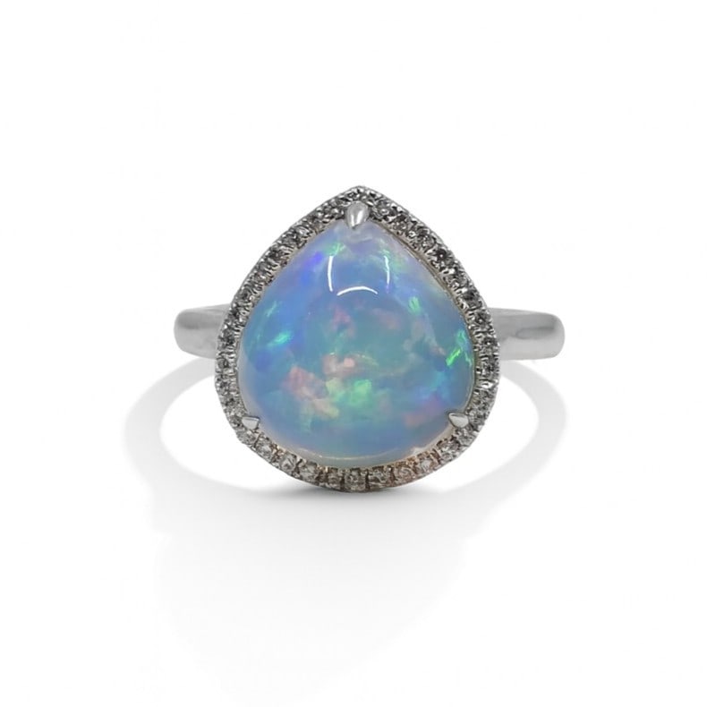 4.52ct Opal and 0.15ctw Diamond 14K White Gold Ring: An exquisite masterpiece of haute joaillerie, this stunning Halo ring featuring Opal, White Diamond is a true treasure. Crafted with precision, the Halo setting is seamlessly integrated into 4.76 g of
