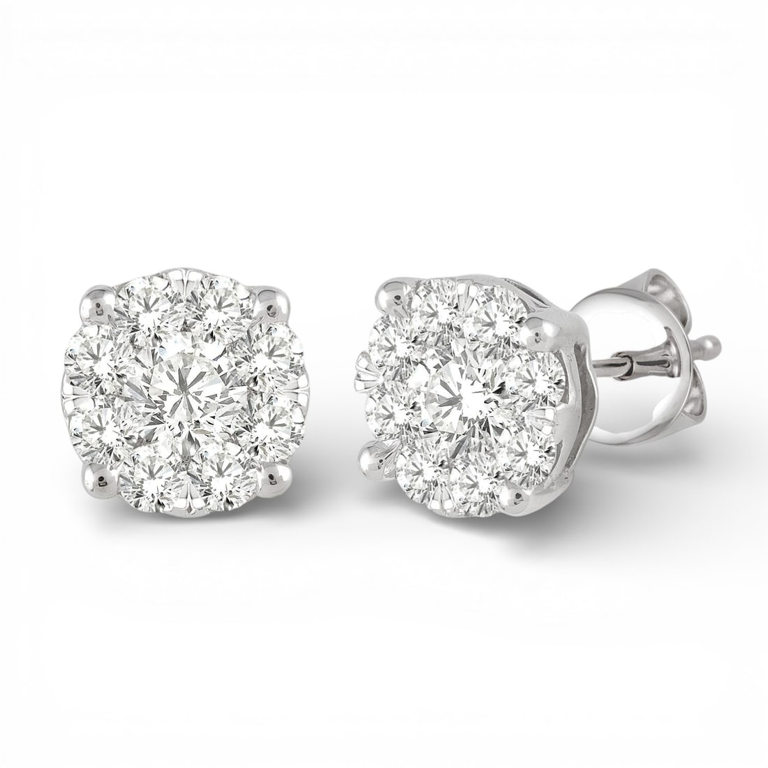 1.04 ctw Round Cut Diamond Cluster 14K White Gold Stud Earrings: Exuding opulence and grace, this elegant Cluster pair of earrings featuring White Diamond is crafted for the distinguished. Showcasing the gems in a Cluster arrangement, the earrings consist of 2.75 g