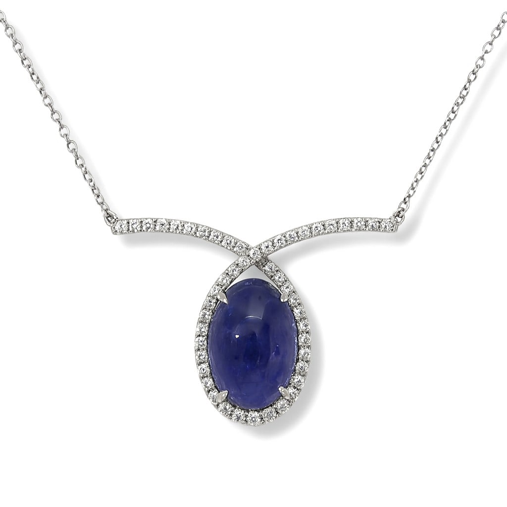 12.24ct Oval Tanzanite and 0.60ctw Diamond 14K White Gold Pendant: Captured in a moment of brilliance, this breathtaking Halo pendant featuring Tanzanite, White Diamond speaks to the connoisseur. Securely held in a classic Halo design, the pendant is forged from high