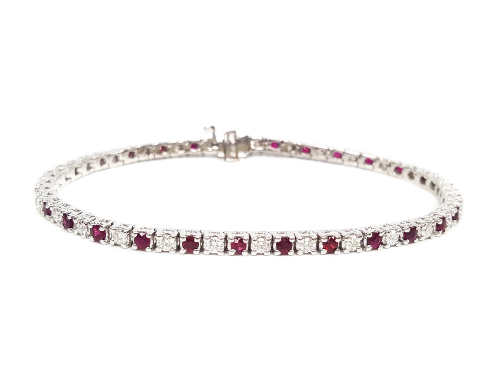 1.60ct Ruby and 1.20ctw Diamond 14K White Gold Tennis Bracelet: Timeless and sophisticated, this elegant Alternating Tennis Bracelet Link bracelet featuring Ruby, White Diamond radiates enduring beauty. Expertly mounted in a Tennis Bracelet Link setting, the brace