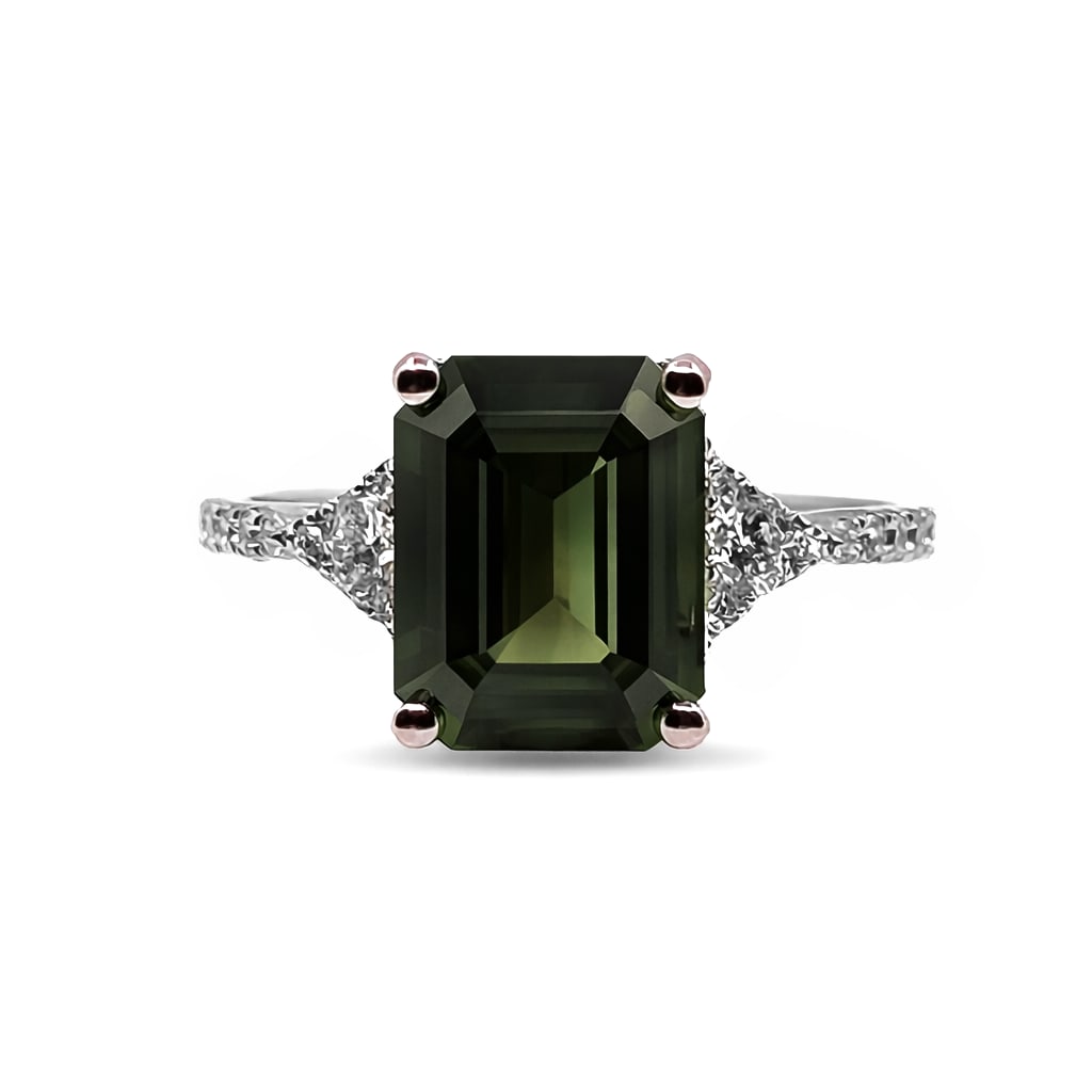 4.10ct Emerald Cut Green Sapphire and 0.32ctw Diamond 18K White Gold Ring: A vision of luxury, this magnificent Three Stone ring featuring Green Sapphire, White Diamond defines sophistication. The gemstones are nestled within a Three-Stone framework, supported by a substanti
