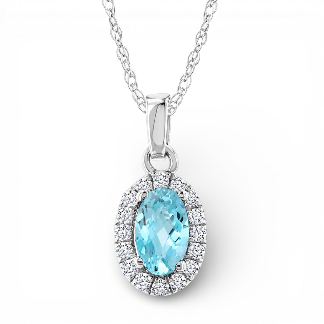 5x3mm Oval Aquamarine and 0.07 ctw Diamond 10K White Gold Pendant: An exquisite masterpiece of haute joaillerie, this elegant Halo pendant featuring Aquamarine, White Diamond is a true treasure. Crafted with precision, the Halo setting is seamlessly integrated into 0