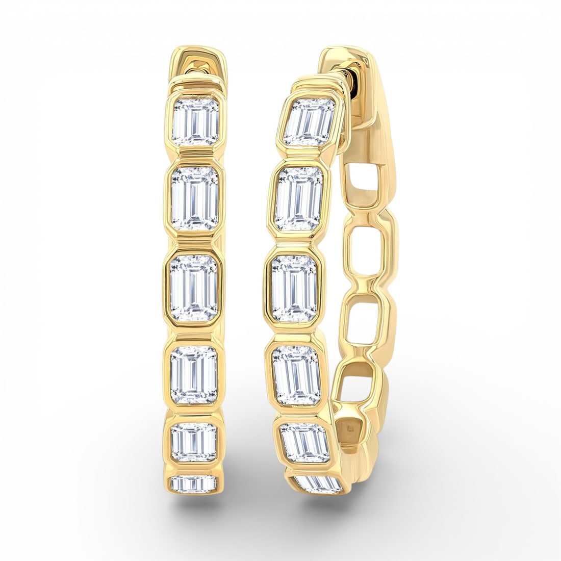 1.08 ctw Emerald Cut Diamond Bezel Set 14K Yellow Gold Hoop Earrings: Captured in a moment of brilliance, this elegant Bezel Set Emerald Cut pair of earrings featuring White Diamond speaks to the connoisseur. The gemstones are nestled within a Bezel framework, supported