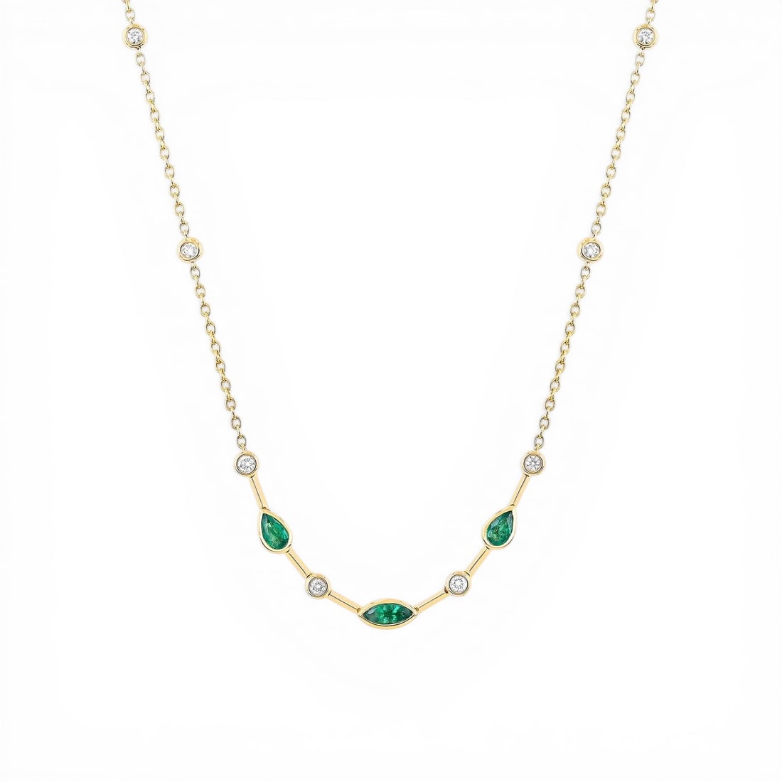 Emerald and 0.28 ctw Diamond 18K Yellow Gold Necklace: Defining modern elegance, this breathtaking Smile necklace featuring Emerald, White Diamond captures the essence of style. Securely held in a classic Bezel-Set Station Necklace design, the necklace is