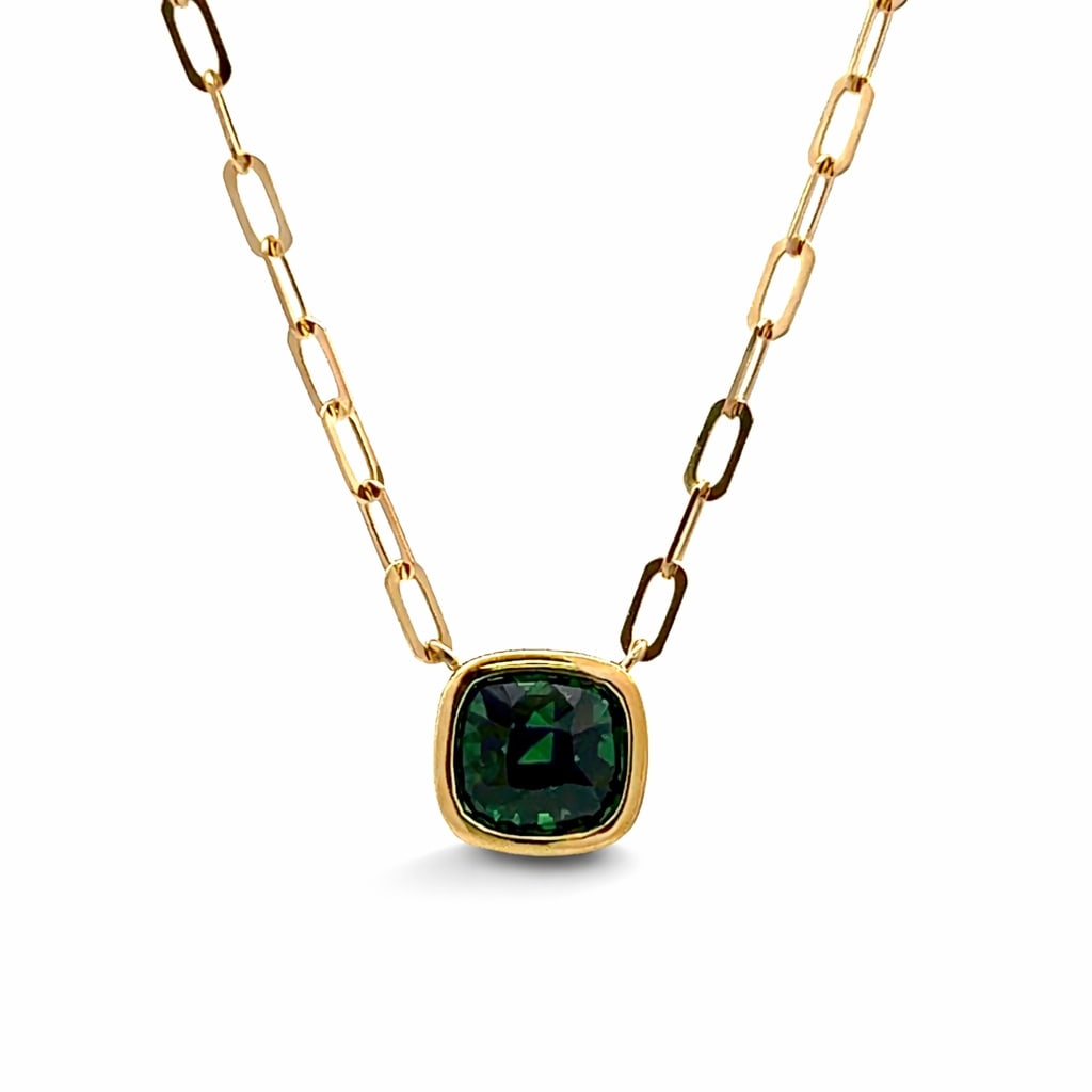 2.16ctw Tsavorite 18K Yellow Gold Pendant: Epitomizing grandeur, this magnificent Bezel pendant featuring Tsavorite stands as a beacon of refined taste. Crafted with precision, the Bezel setting is seamlessly integrated into lustrous 18K Yello