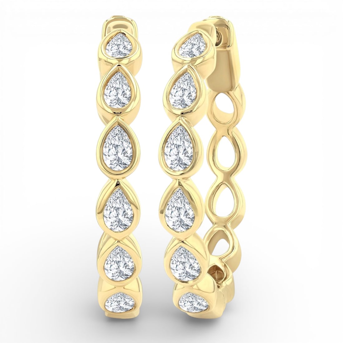 1.00 ctw Pear Cut Diamond Bezel Set Fashion Hoop 14k Yellow Gold Earrings: Rare and radiant, this elegant Hoop pair of earrings featuring White Diamond offers a touch of the extraordinary. Showcasing the gems in a Bezel arrangement, the earrings consists of 4.85 g of 14K Yel