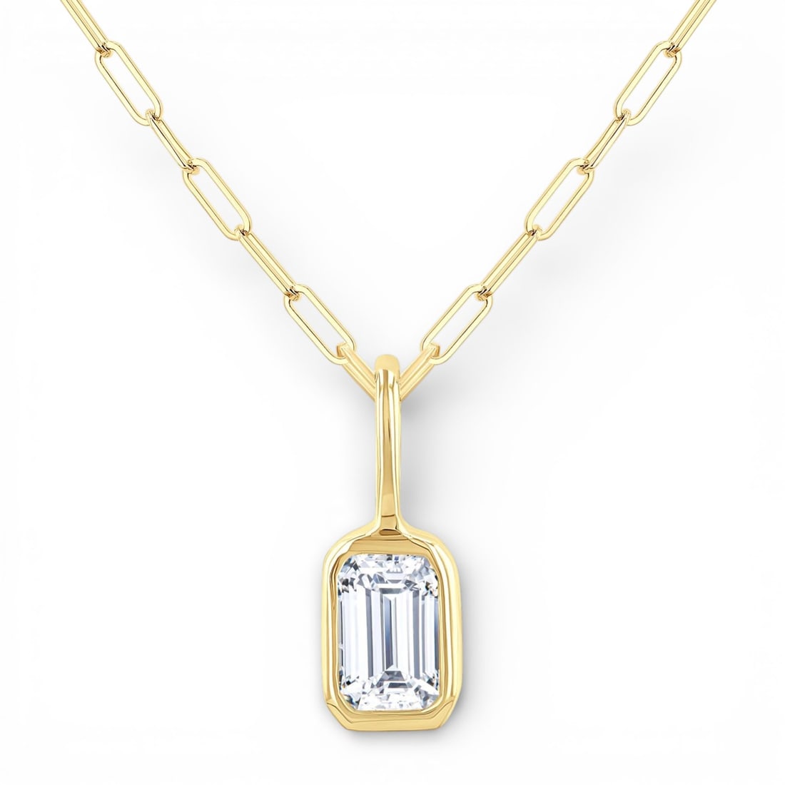 0.21 ctw Emerald Cut Diamond Bezel Set 14K Yellow Gold Pendant Necklace: Defining modern elegance, this stunning Bezel Set necklace featuring White Diamond captures the essence of style. Securely held in a classic Solitaire design, the necklace is forged from 0.23 grams of