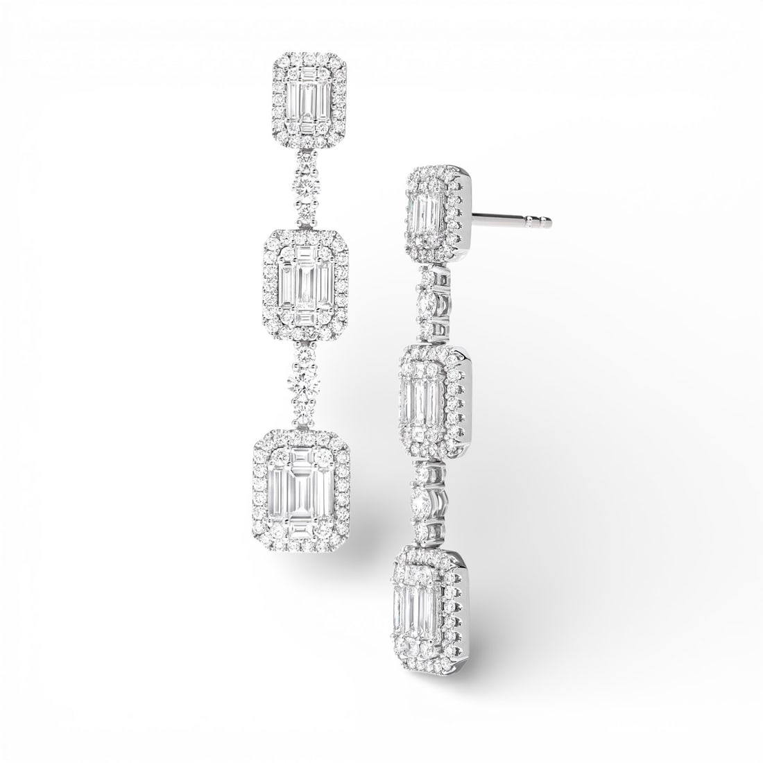 2.95 ctw Baguette & Round Diamond 18K White Gold Earrings: Captured in a moment of brilliance, this breathtaking Graduating Station pair of earrings featuring White Diamond speaks to the connoisseur. Securely held in a classic Halo design, the earrings are fo