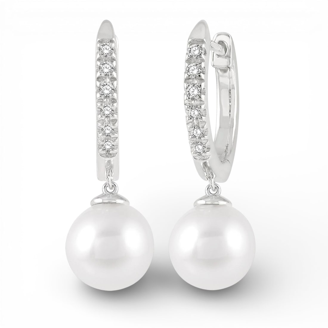6mm Cultured Pearl and 0.12 ctw Diamond 10K White Gold Earrings: A symphony of light and color, this elegant Drop Petite Huggie pair of earrings featuring Cultured Pearl, White Diamond embodies the pinnacle of luxury. The gemstones are nestled within a Drop framewo