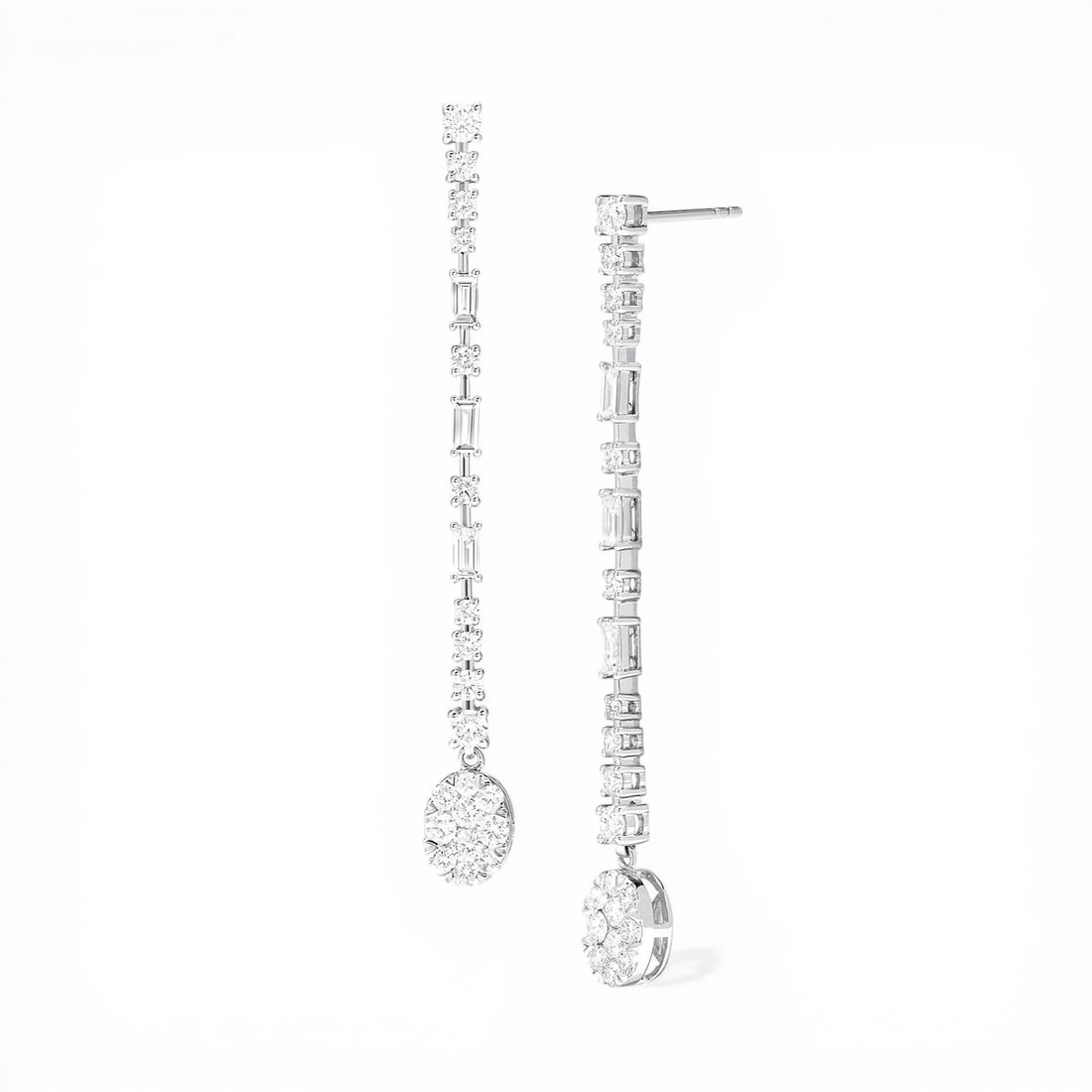 2.06 ctw Diamond Fiori Oval & Baguette Drop Cluster 18K White Gold Earrings: Captured in a moment of brilliance, this stunning Fiori Drop Cluster pair of earrings featuring White Diamonds speaks to the connoisseur. The gemstones are nestled within a Cluster framework, supporte