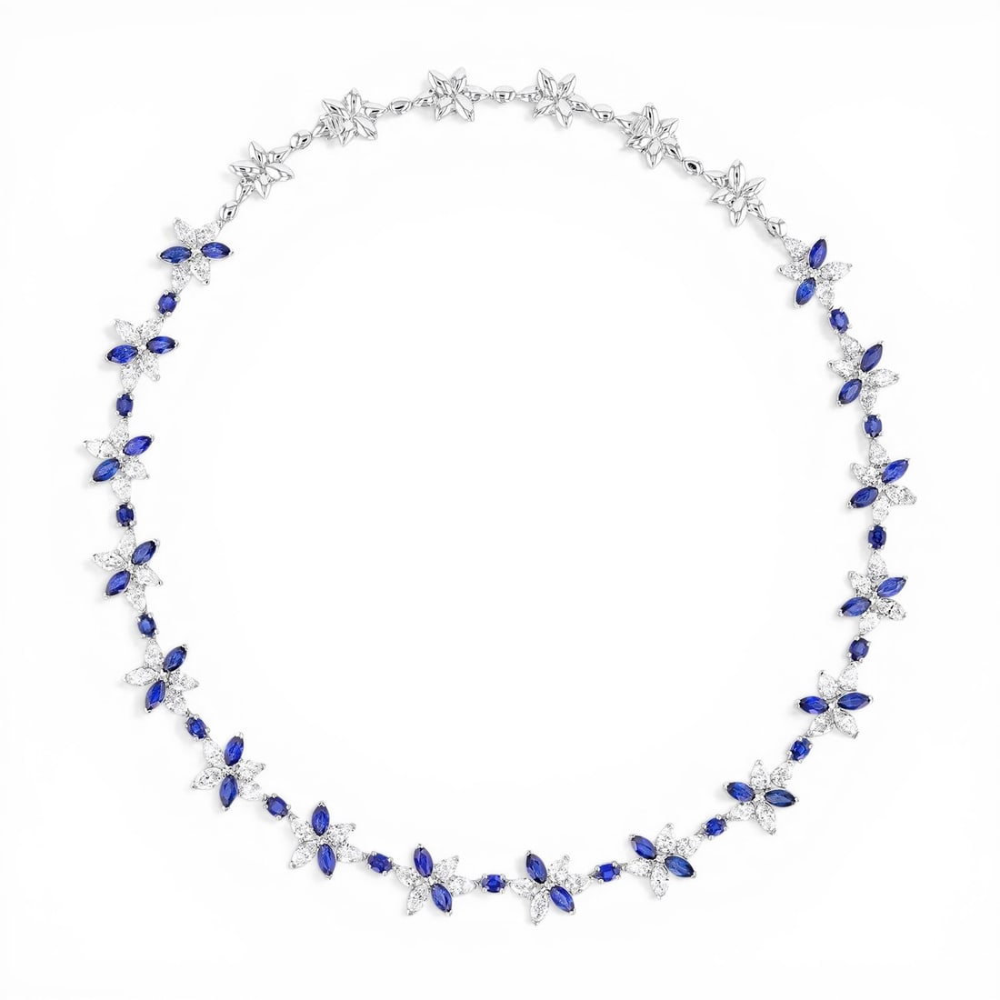 16 inch Blue Sapphire and 11.96 ctw White Diamond Platinum Necklace: An exquisite masterpiece of haute joaillerie, this magnificent Floral necklace featuring Blue Sapphire, White Diamond is a true treasure. Showcasing the gems in a Cluster arrangement, the necklace con