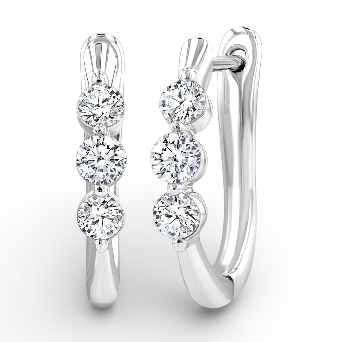 0.50 ctw Three-Stone White Diamond Fashion 14K White Gold Hoop Earrings: A testament to superior craftsmanship, this elegant Three-Stone pair of earrings featuring White Diamond is unparalleled. A detailed Three-Stone gallery secures the stones, rendered in 2.6 grams of lu