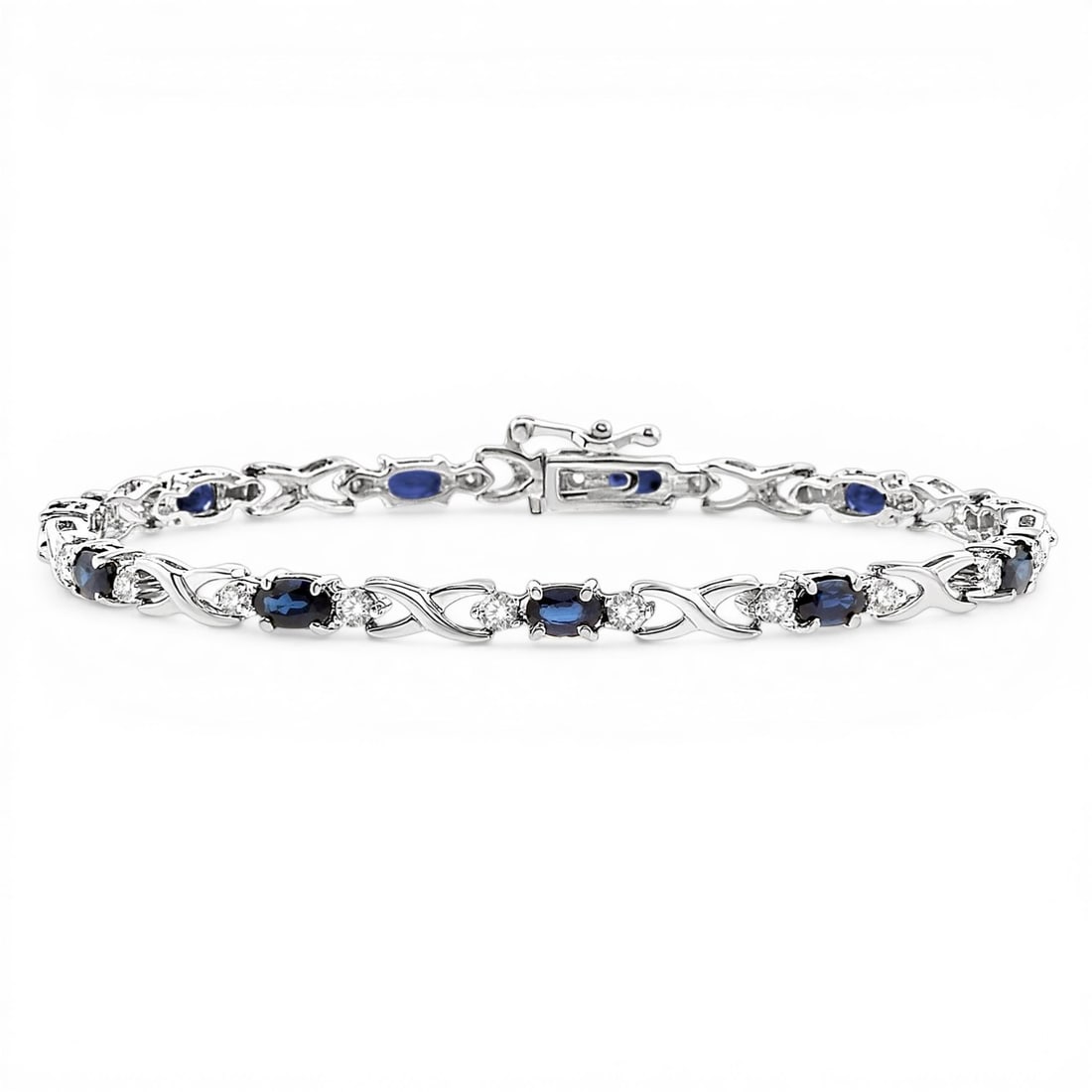 5x3mm Oval Sapphire and 0.10 ctw Diamond 10K White Gold Bracelet: Timeless and sophisticated, this elegant tennis bracelet featuring Blue Sapphire, White Diamond radiates enduring beauty. Expertly mounted in a Link setting, the bracelet is crafted in 7.8 grams of so