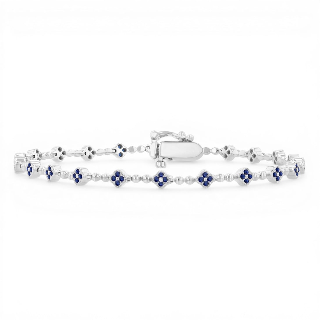 1mm Round Blue Sapphire Clover Link 14K White Gold Tennis Bracelet: Captured in a moment of brilliance, this exquisite Clover bracelet featuring Blue Sapphire speaks to the connoisseur. The gemstones are nestled within a Cluster framework, supported by a substantial 8