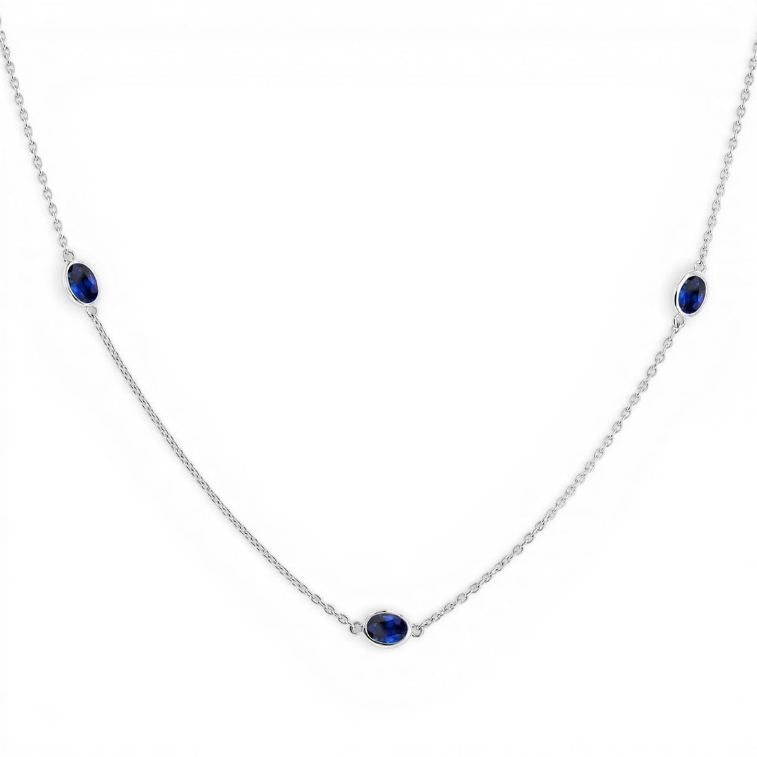 4x3 mm Oval Sapphire 14K White Gold Station Necklace: Rare and radiant, this elegant Station necklace featuring Blue Sapphire offers a touch of the extraordinary. Crafted with precision, the Bezel setting is seamlessly integrated into 2.45 grams of 14K W