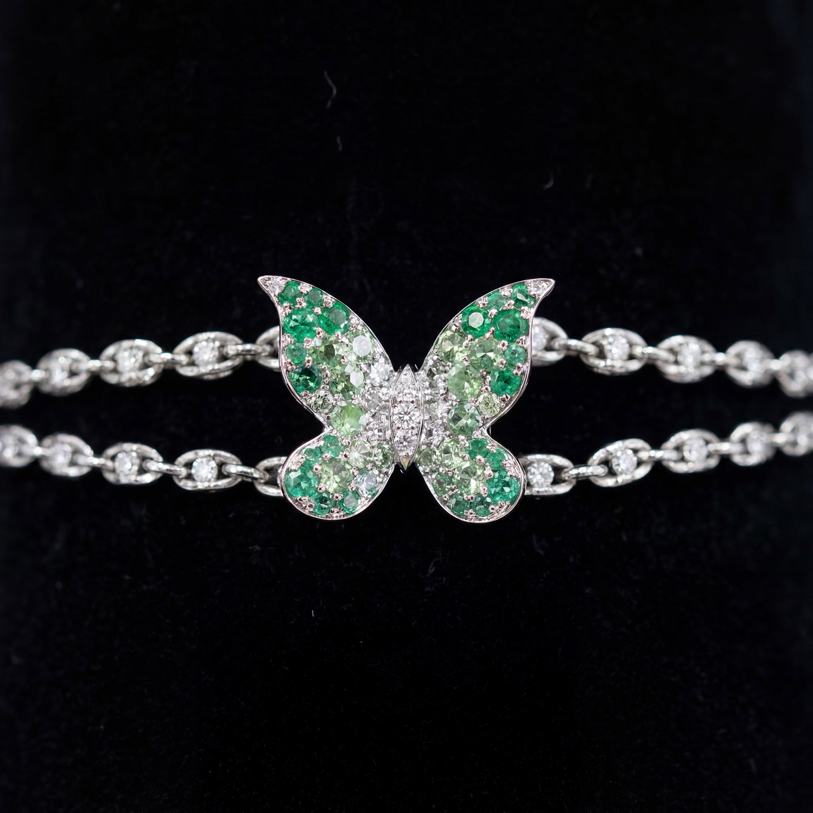 1.40 ctw Emerald and 0.45ct Diamond Platinum Bracelet: Retail Value: $8,565 A vision of luxury, this exquisite Butterfly Glister bracelet featuring Emerald, Tsavorite, White Diamond defines sophistication. Securely held in a classic Station design, the br