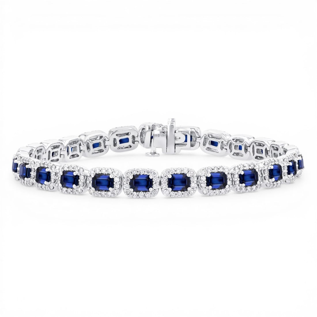 4x3mm Emerald Cut Blue Sapphire and 2.20 ctw Diamond 14K White Gold Bracelet: Exuding opulence and grace, this breathtaking Halo bracelet featuring Blue Sapphire, White Diamond is crafted for the distinguished. Showcasing the gems in a Halo arrangement, the bracelet consists of