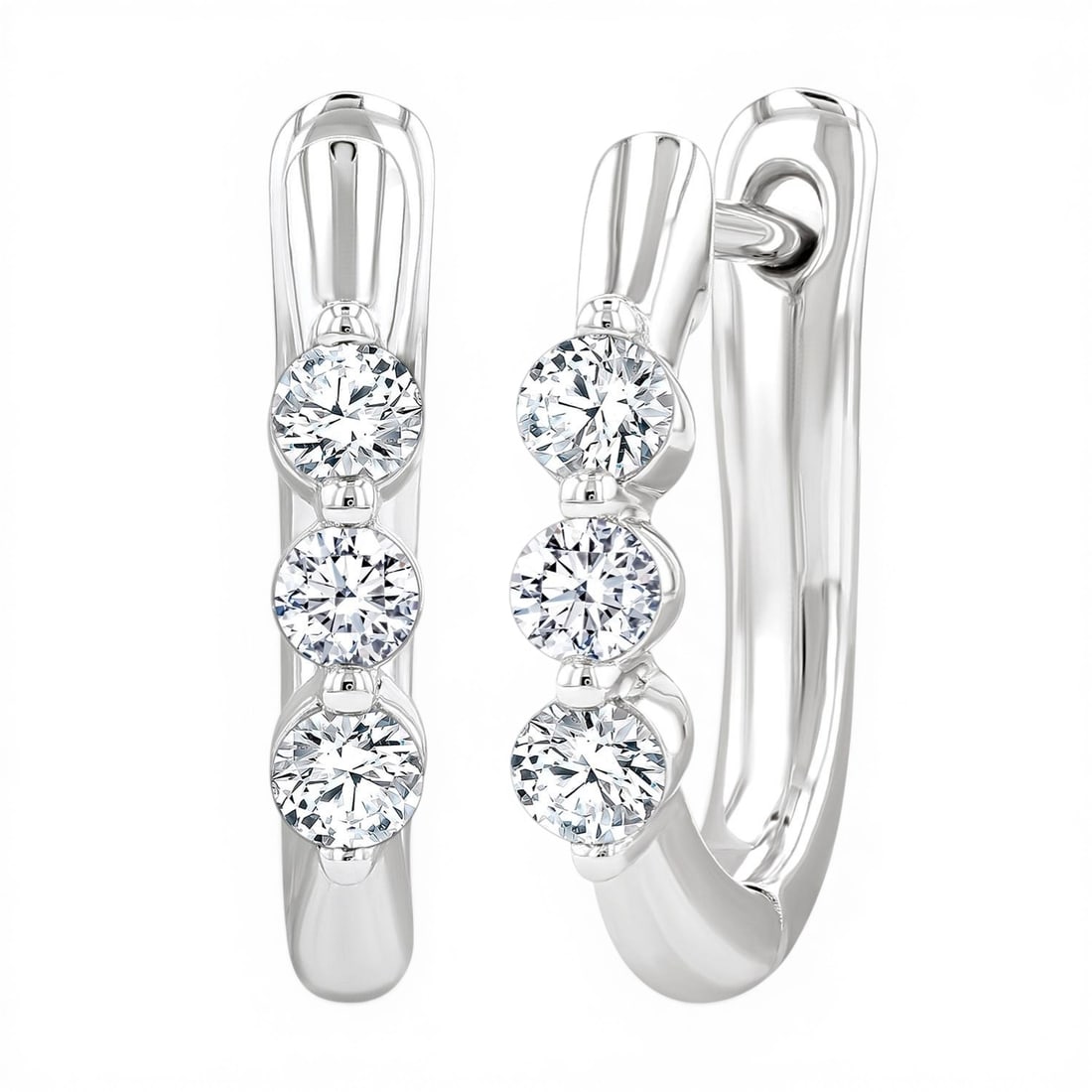 0.34 ctw Diamond 14K White Gold Hoop Earrings: Rare and radiant, this stunning Three-Stone pair of earrings featuring White Diamond offers a touch of the extraordinary. A detailed Three-Stone gallery secures the stones, rendered in 2.35 grams of l
