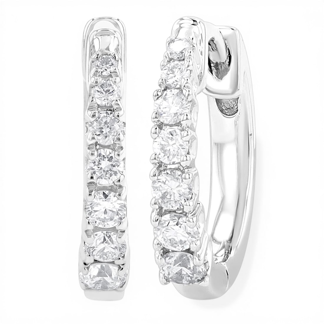 0.25 ctw Round Cut Diamond Graduated Huggie 10K White Gold Earrings: Captured in a moment of brilliance, this elegant Graduated pair of earrings featuring White Diamond speaks to the connoisseur. The gemstones are nestled within a Huggie framework, supported by a subst